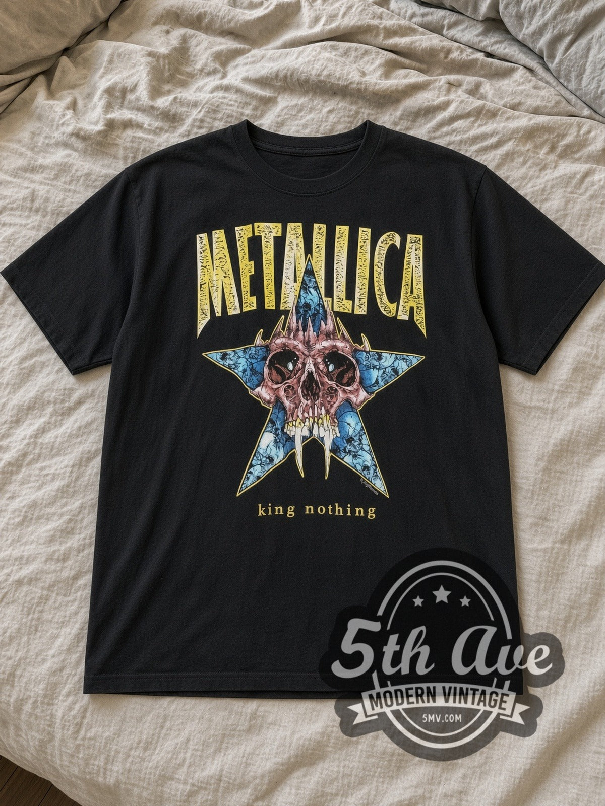 Black Metallica King Nothing Fanged Skull Blue Star Vintage Band T-Shirt laid flat on a linen bed