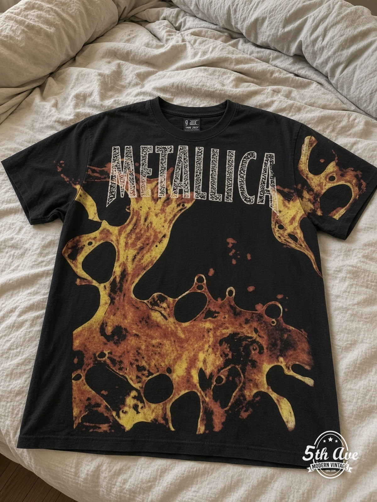 Metallica Liquid Fire all over print vintage tee laid on bed