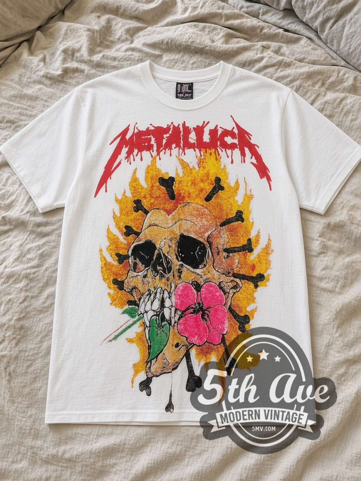 White Metallica Pushead Artwork All Over Print Vintage Band T-Shirt laid flat on a linen bed