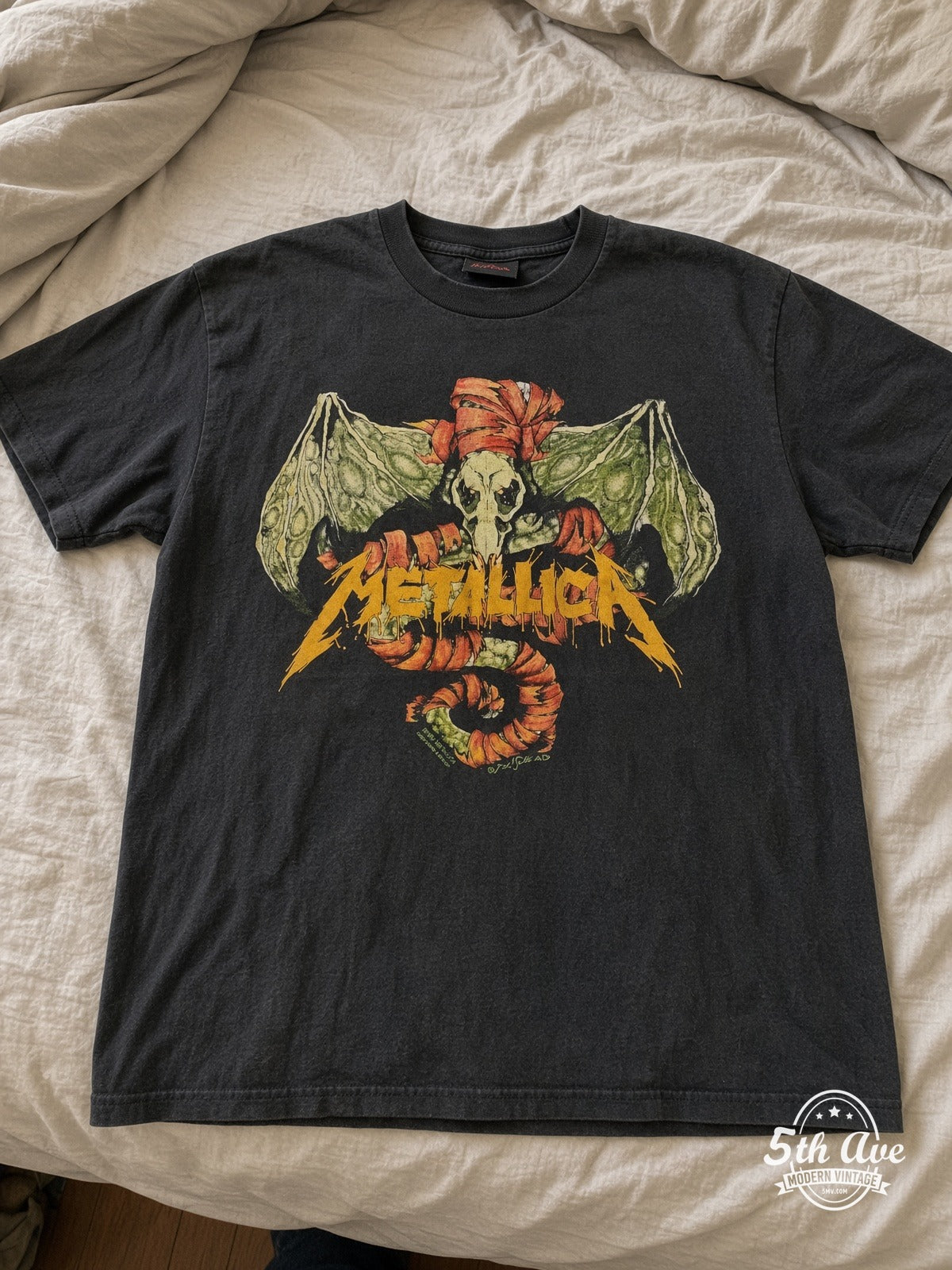 Metallica Wherever I May Roam Winged Skull vintage tee laid on bed