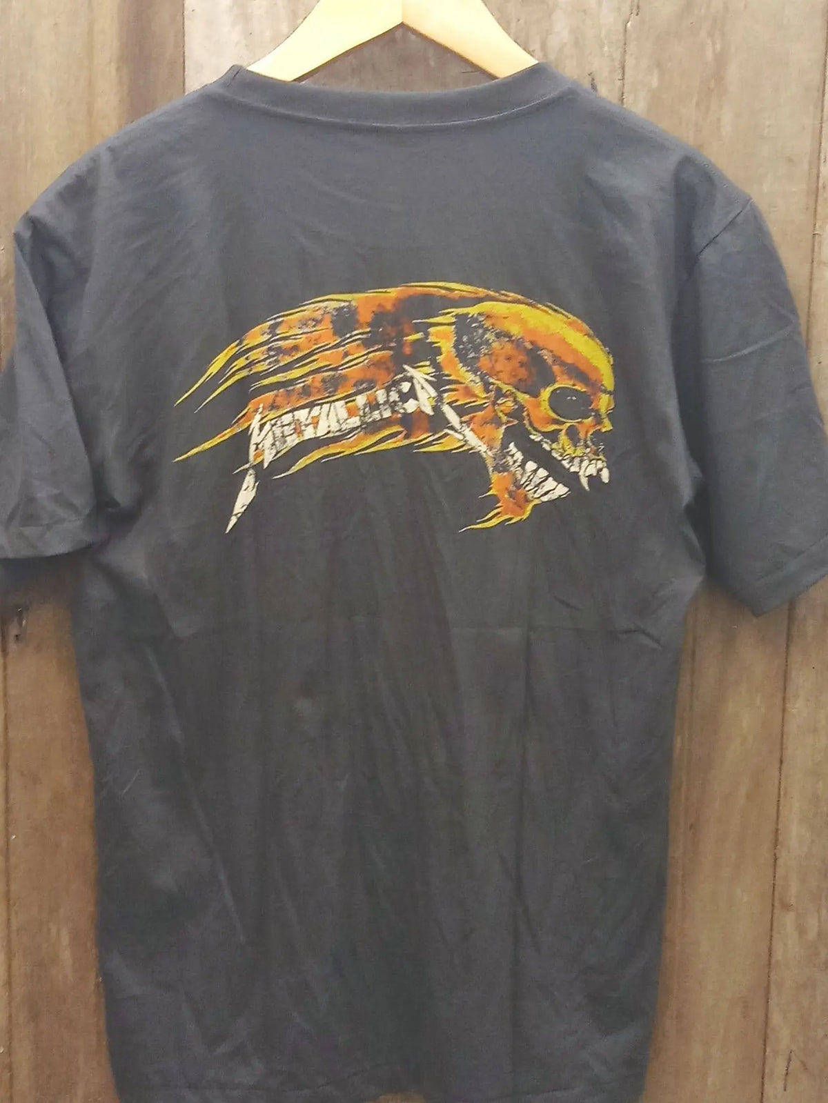 Metallica Skull Sun Flaming Skull Artwork Cotton T-Shirt vintage t-shirt laid on bed