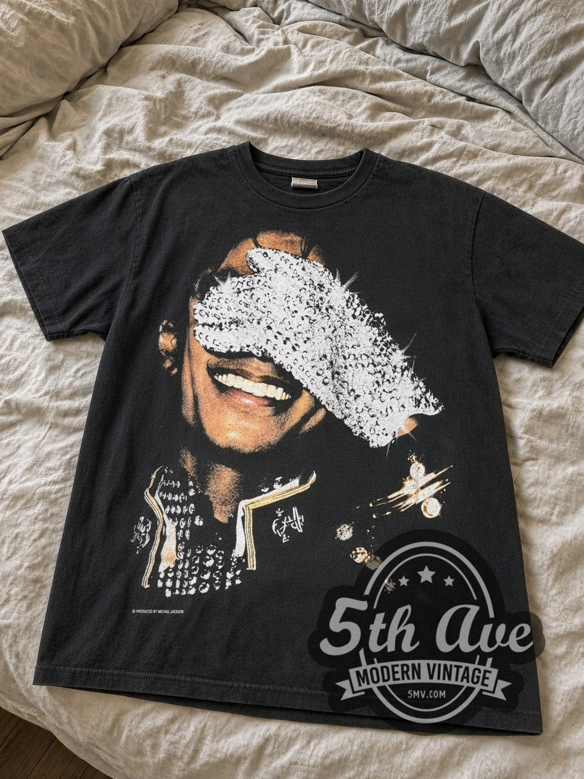 Faded black Michael Jackson sequin glove tee laid flat on linen bed