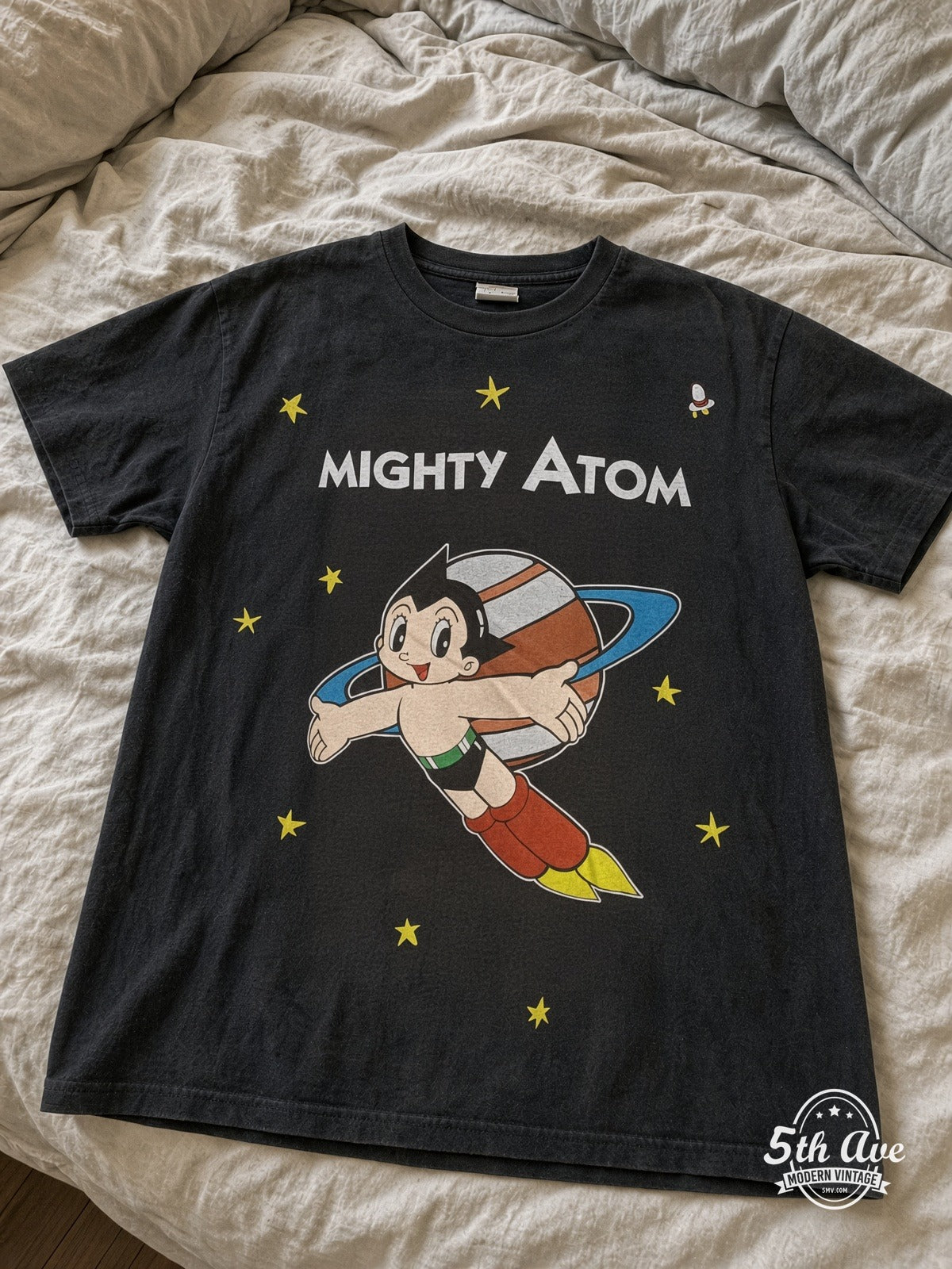 Astro Boy Mighty Atom Flying Portrait vintage tee laid on bed
