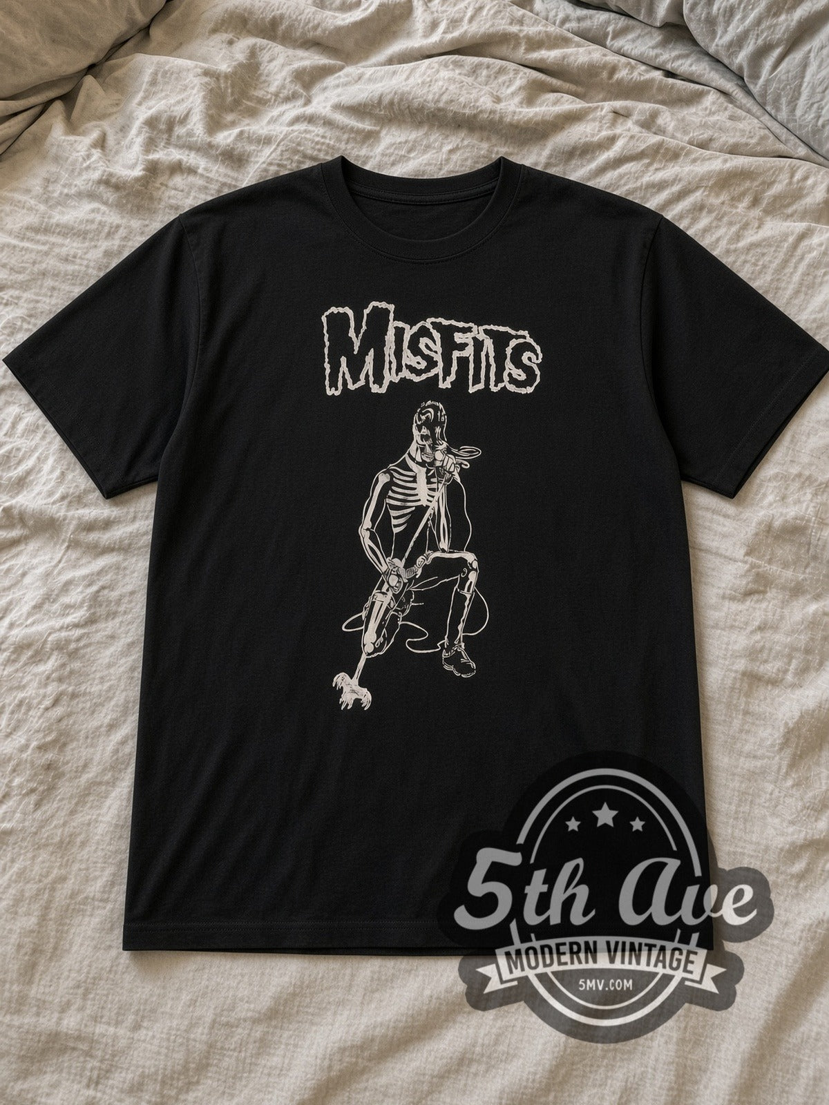 Black Misfits Kneeling Fiend with Microphone Vintage Band T-Shirt laid flat on a linen bed