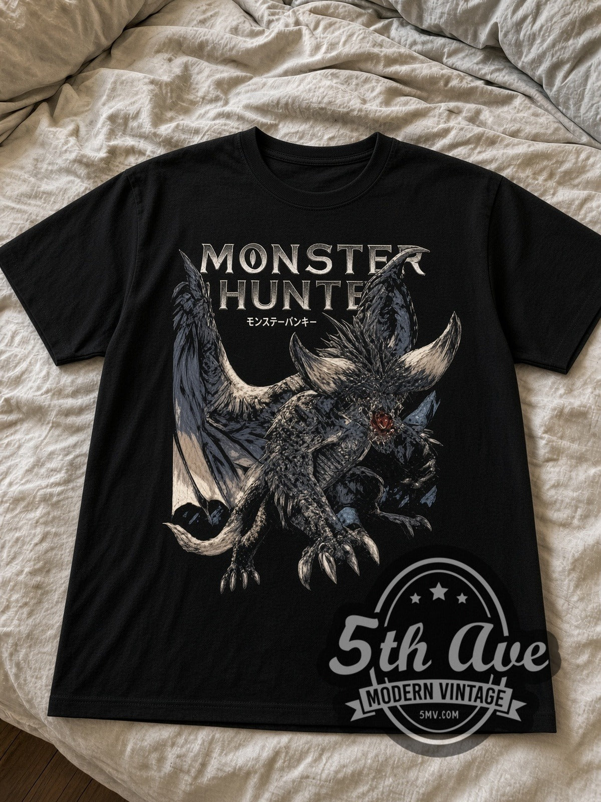 Monster Hunter Nergigante black graphic tee laid flat on linen bed
