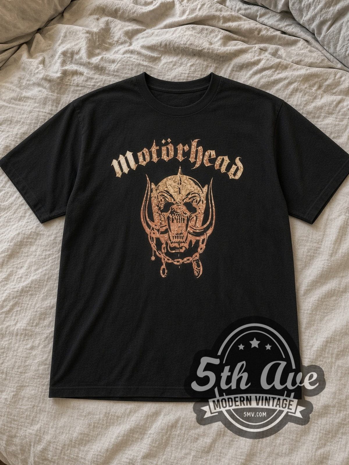 Black Motörhead Explosive with Captain Boot Tag Vintage Band T-Shirt laid flat on a linen bed