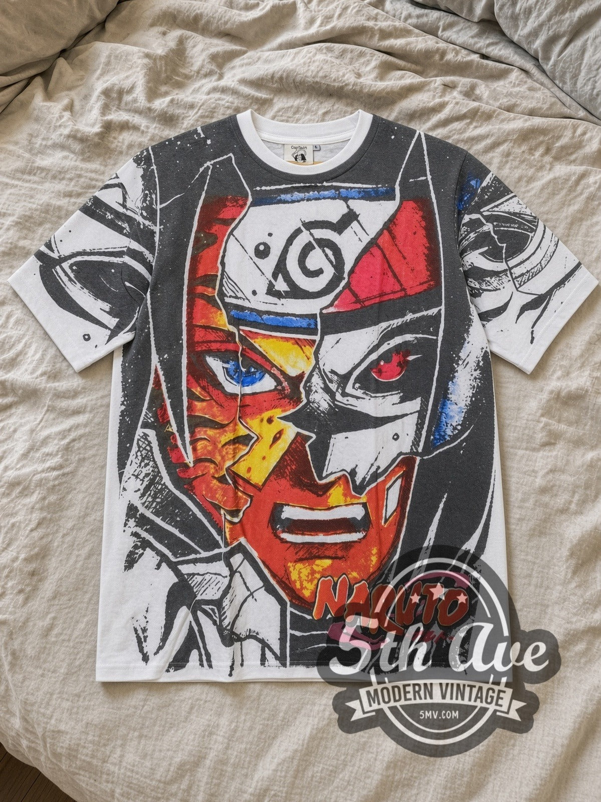 White Naruto Shippuden Split Face Hidden Leaf All Over Print Vintage Anime T-Shirt laid flat on a linen bed