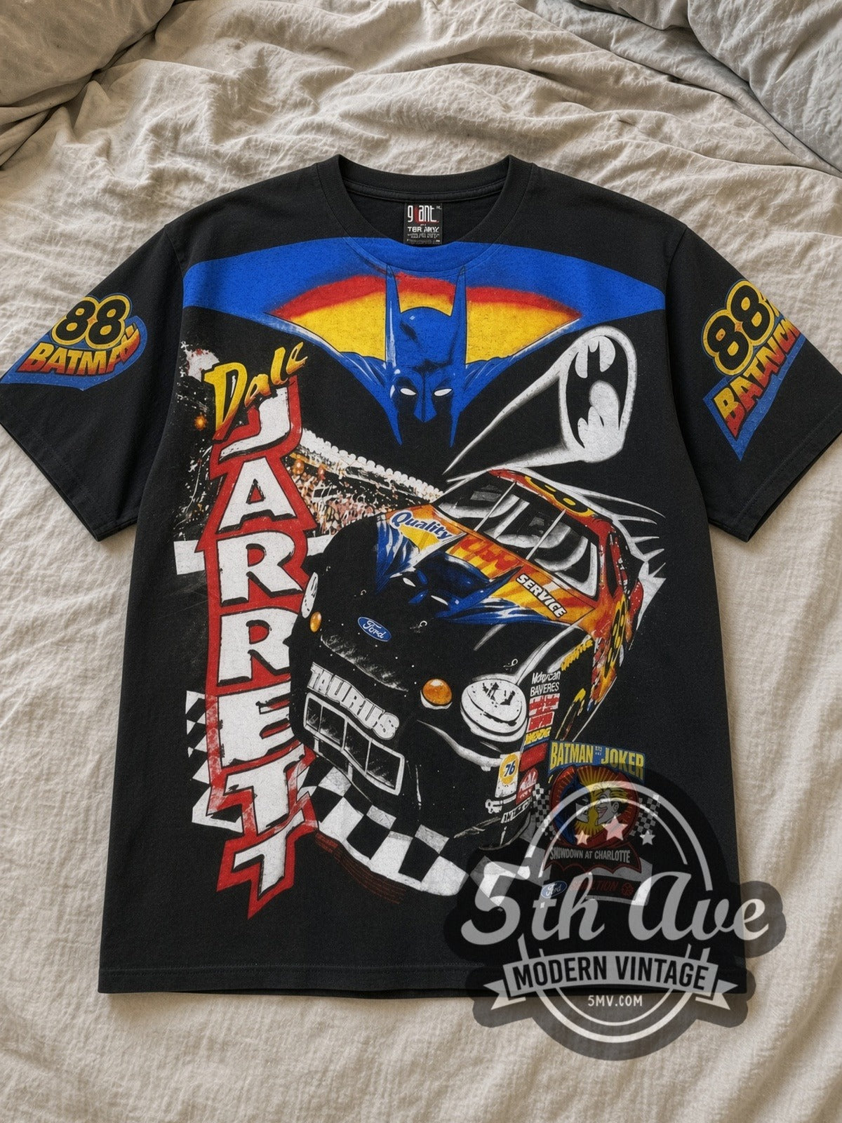 Black NASCAR / Dale Jarrett Batman Ford Taurus Black All Over Print Vintage NASCAR T-Shirt laid flat on a linen bed