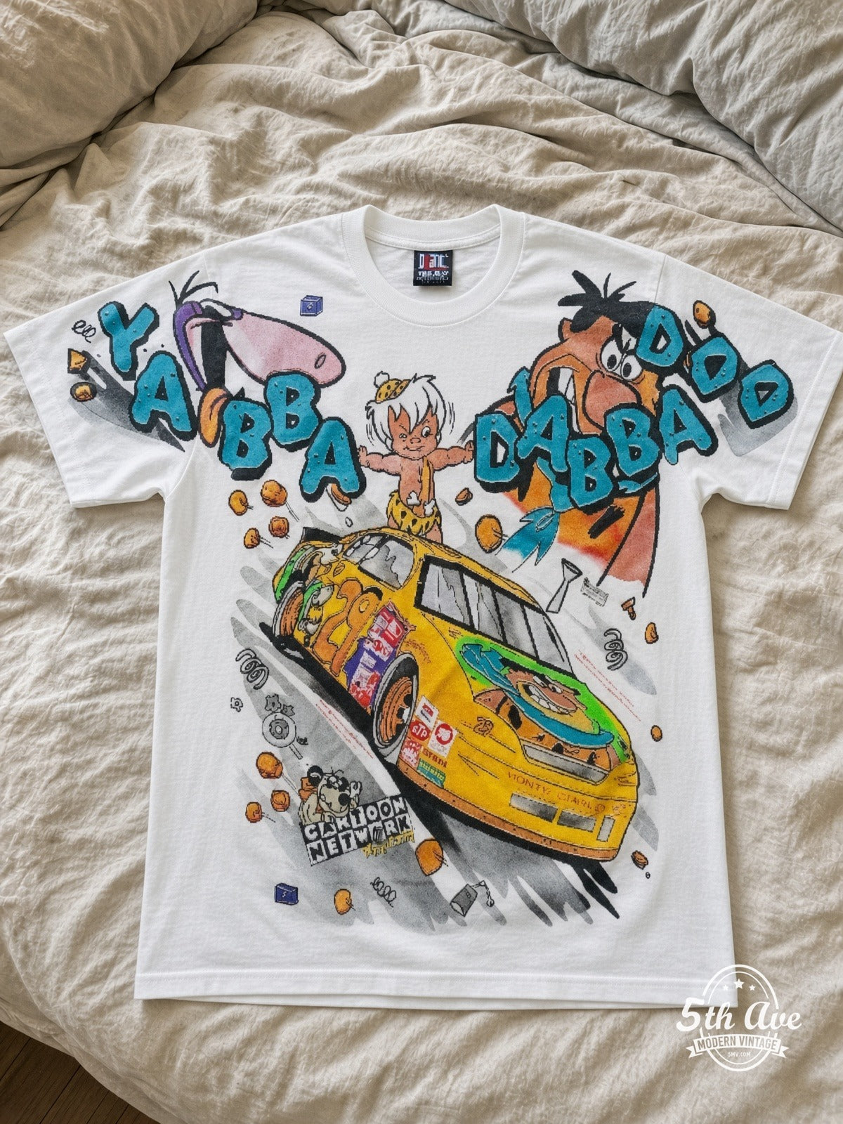 NASCAR Flintstones Yabba Dabba Doo Racing vintage tee laid on bed