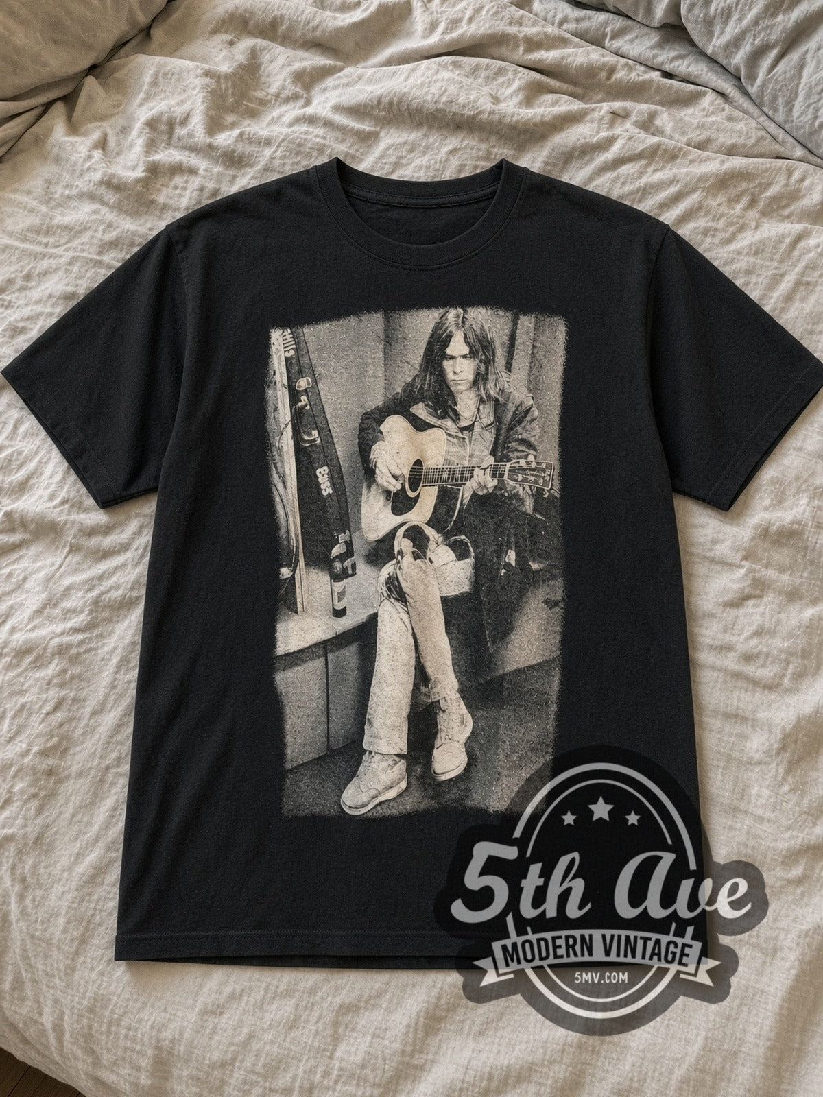 Black Neil Young Acoustic Guitar Bass Case Portrait Vintage Band T-Shirt laid flat on a linen bed
