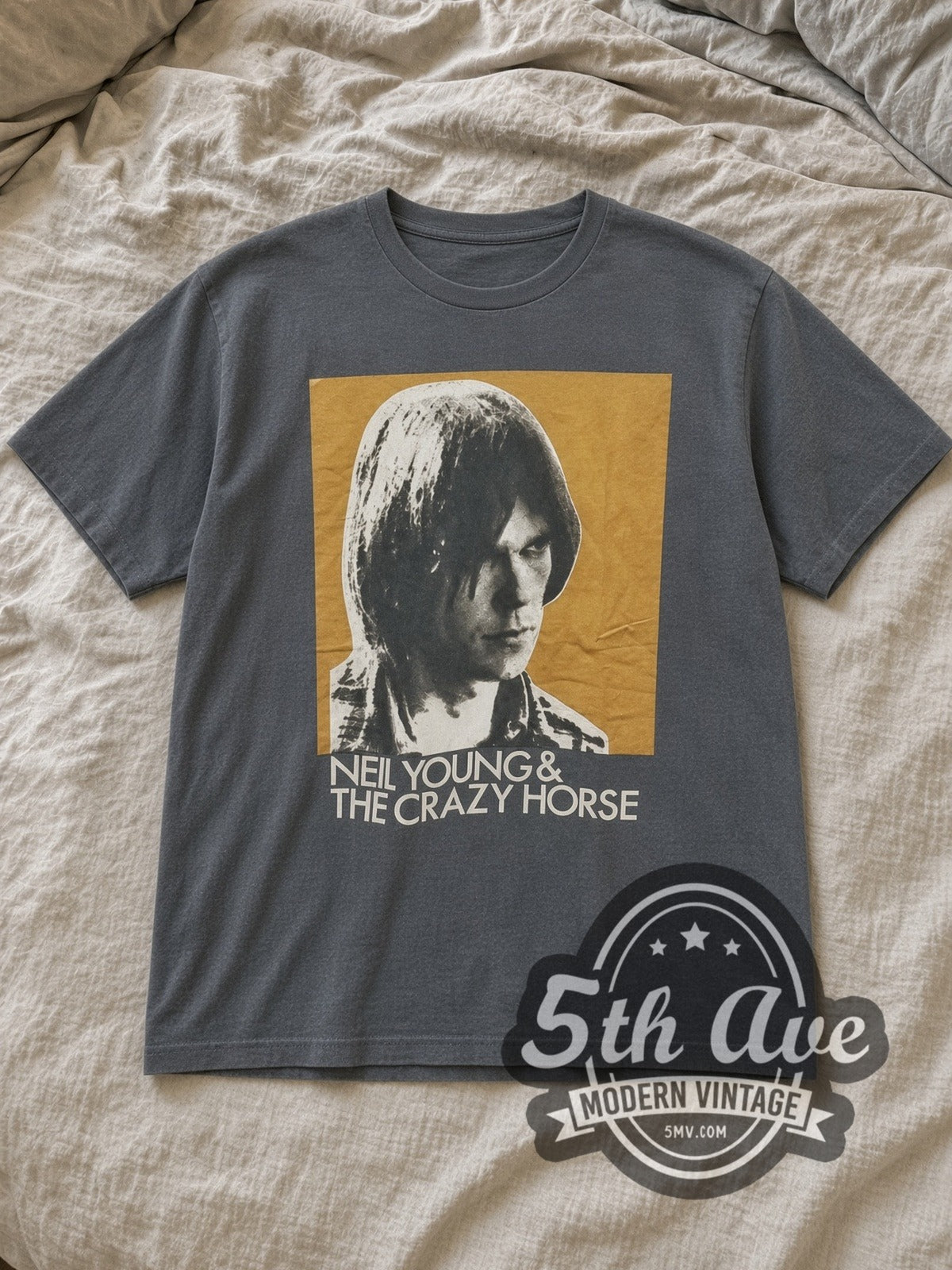 Charcoal Neil Young and Crazy Horse Color Portrait Vintage Band T-Shirt laid flat on a linen bed