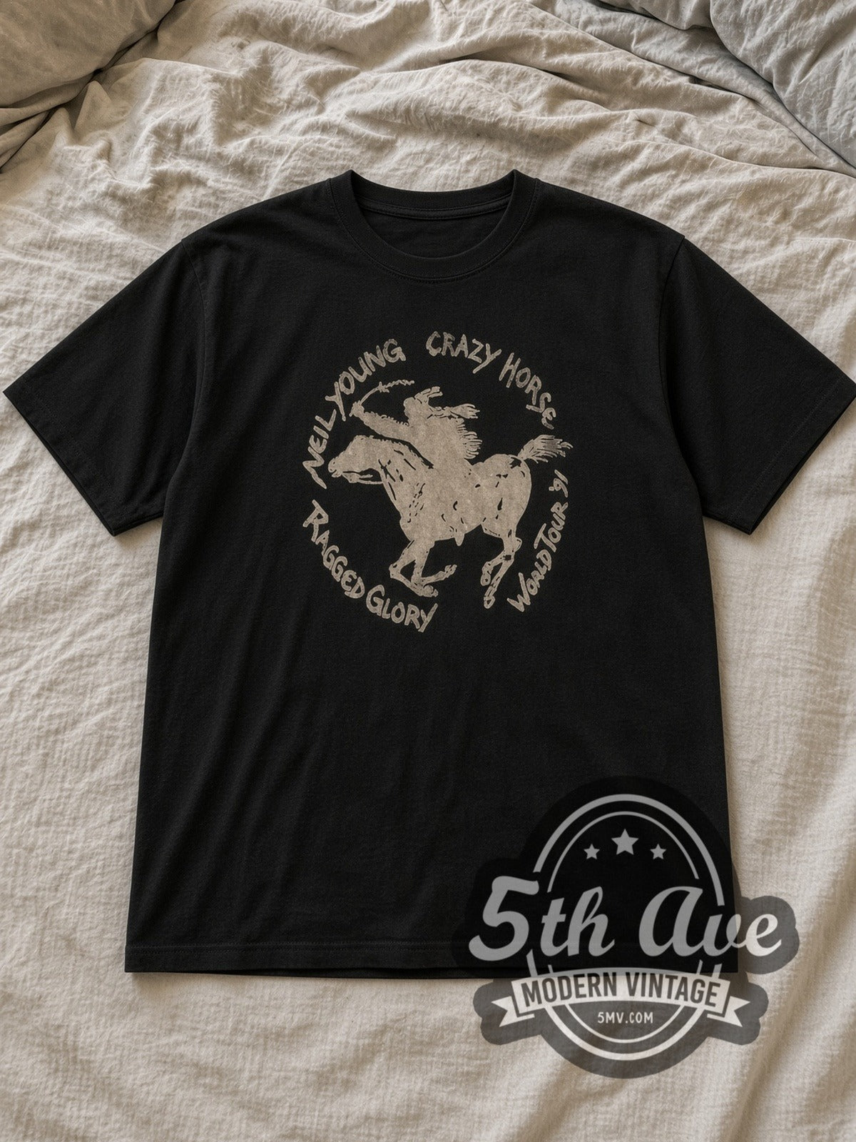 Black Neil Young Crazy Horse 'Ragged Glory World Tour '91 Vintage Band T-Shirt laid flat on a linen bed