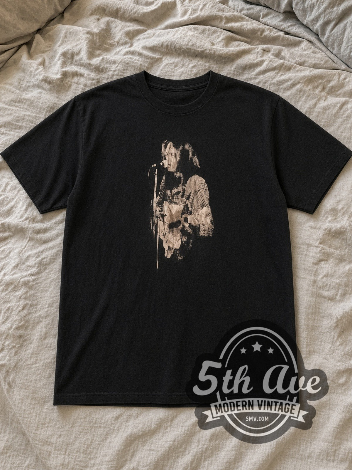 Black Neil Young Black and White Performance with Captain Boot Tag Vintage Band T-Shirt laid flat on a linen bed