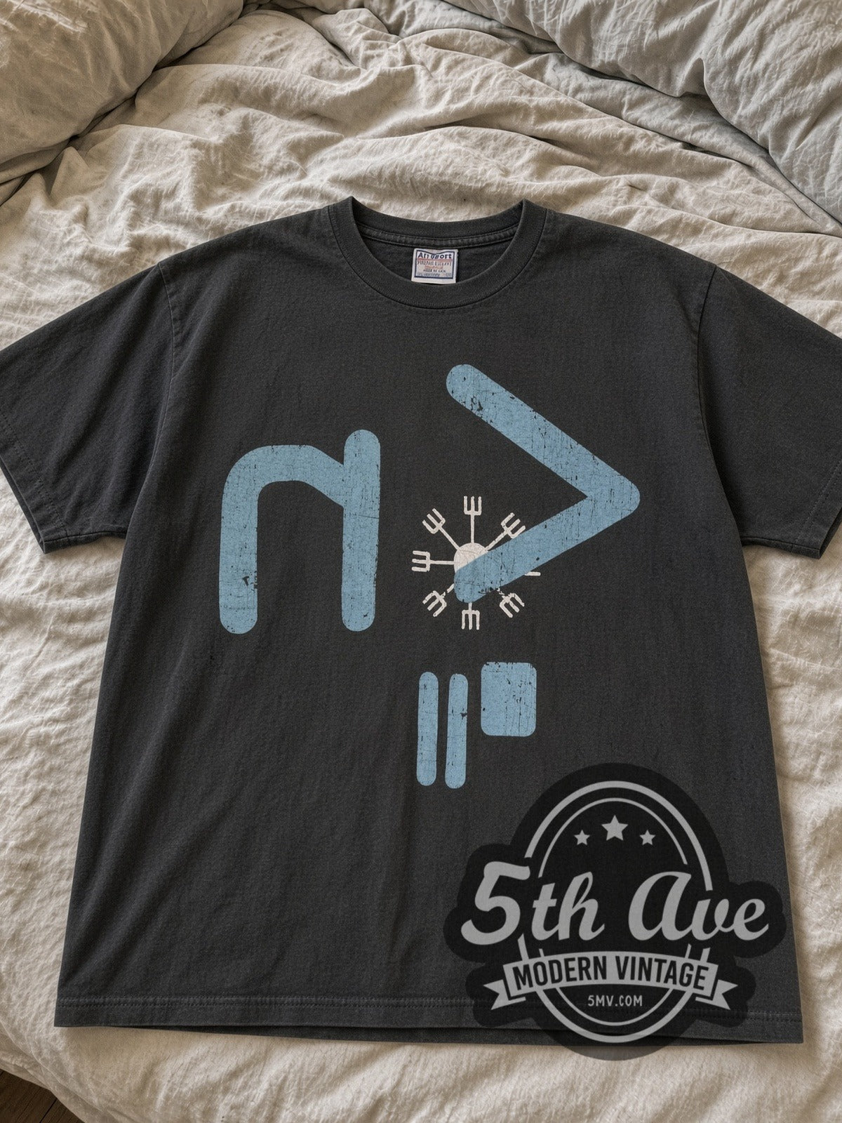 Faded black Nine Inch Nails blue NIN logo tee laid flat on linen bed
