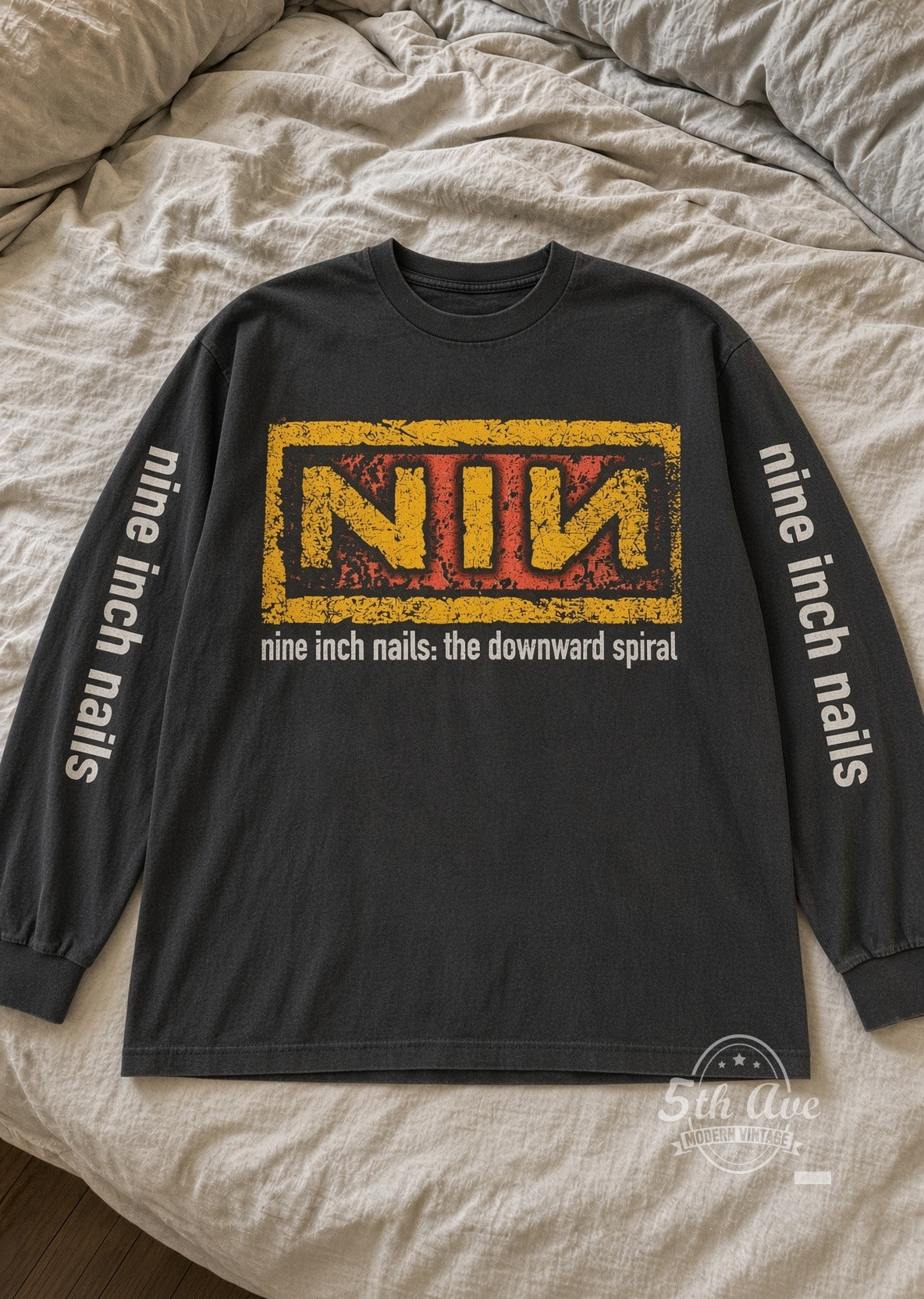 Nine Inch Nails Downward Spiral Yellow NIN Logo Long Sleeve vintage band t-shirt laid flat on bed