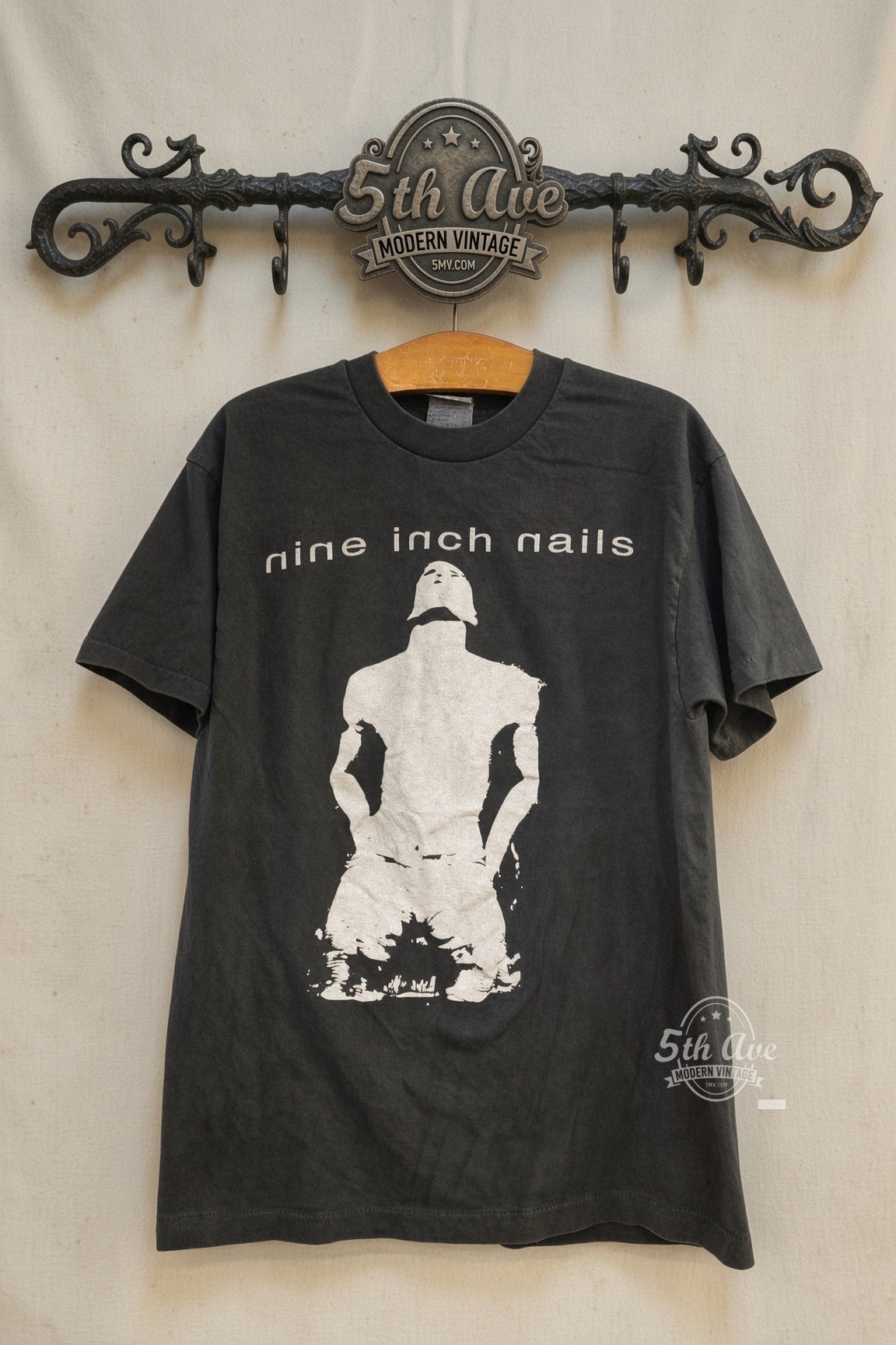 Nine Inch Nails Kneeling Figure NIN Logo vintage band t-shirt front on cream 5th Ave rack