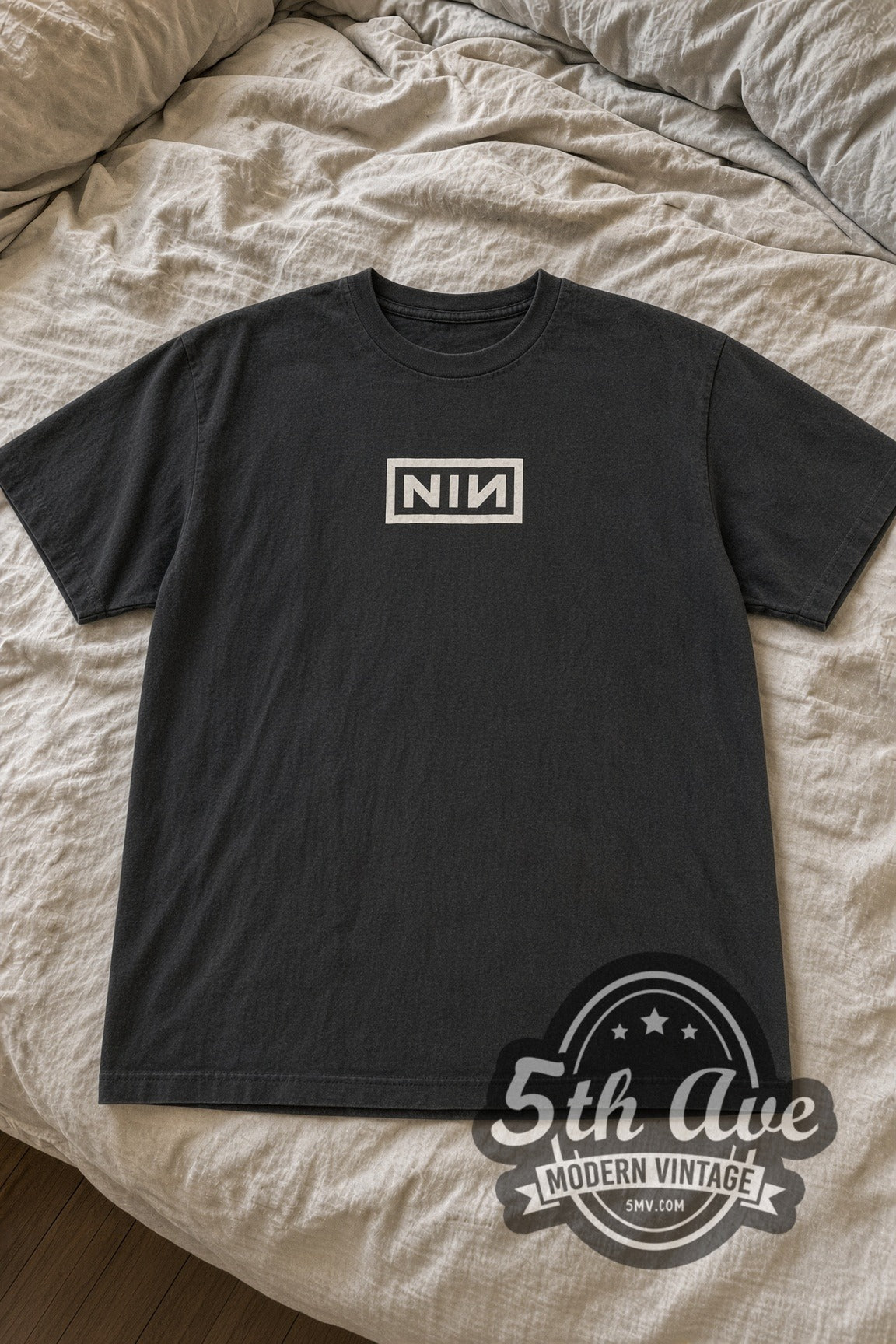 Nine Inch Nails Small Boxed NIN Logo vintage band t-shirt laid flat on bed