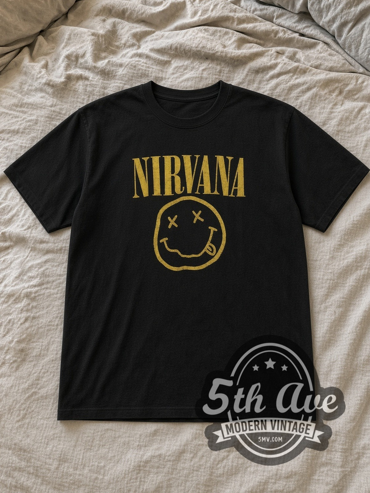 Black Nirvana with Kurt Cobain's Sub Pop Records Sketch Vintage Band T-Shirt laid flat on a linen bed