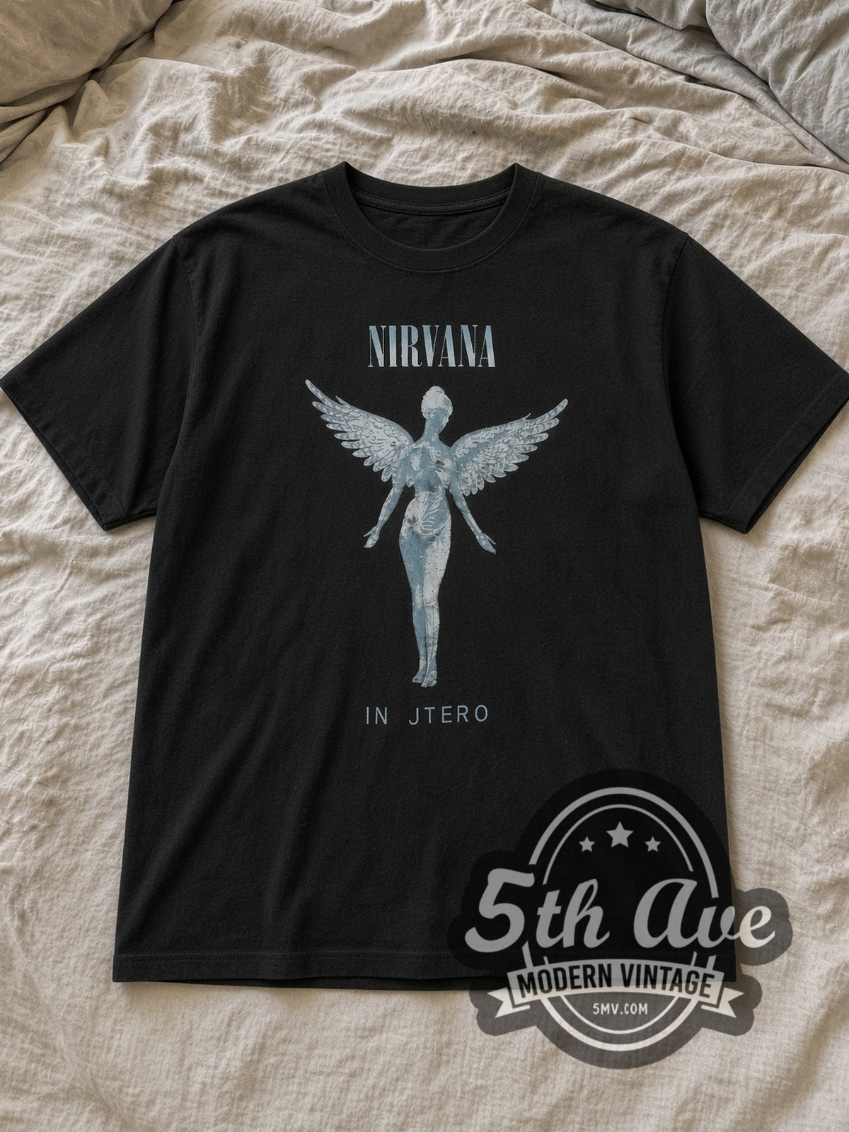 Black Nirvana In Utero Anatomical Angel Charcoal Vintage Band T-Shirt laid flat on a linen bed