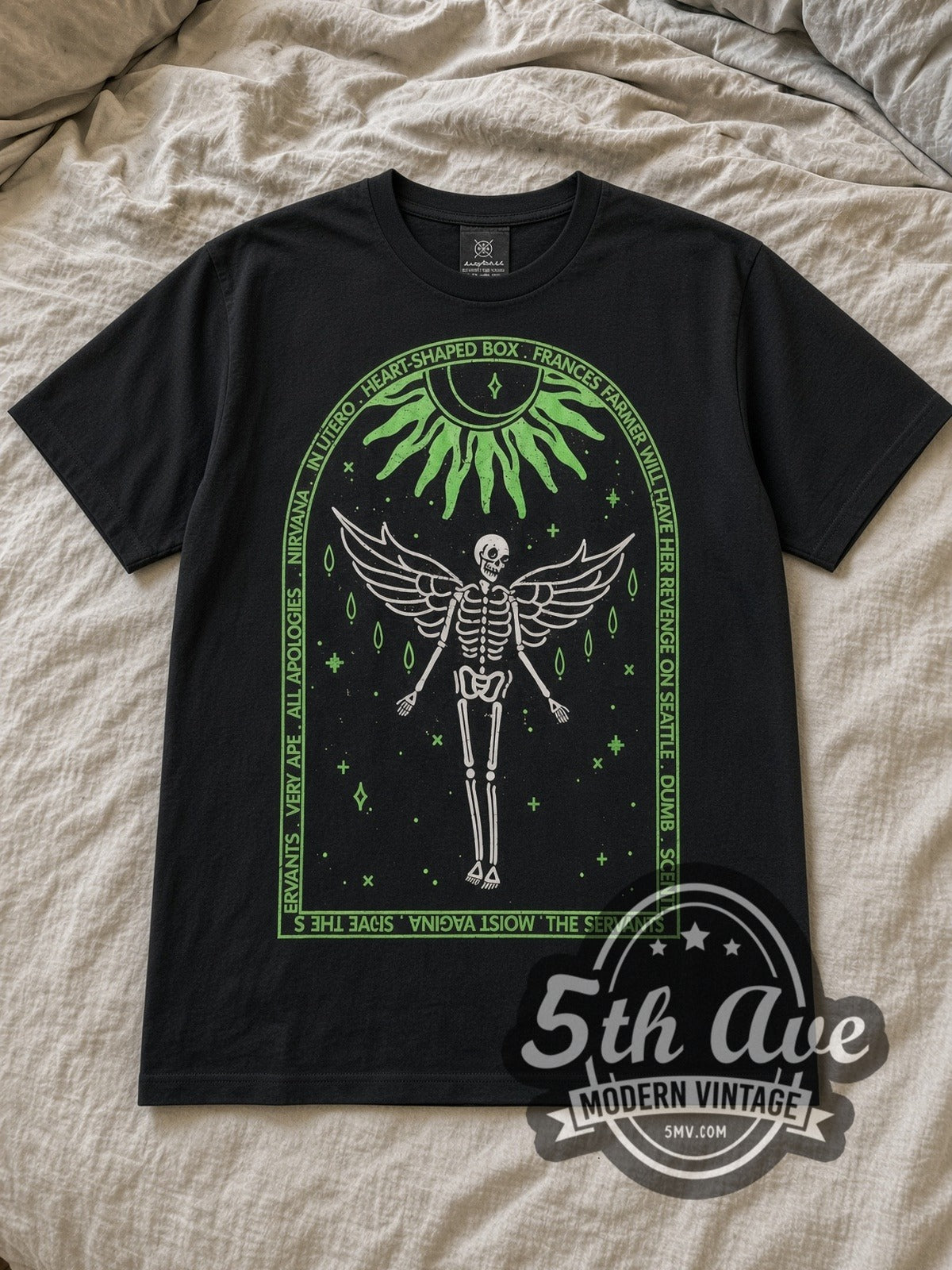 Black Nirvana In Utero Tracklist Winged Skeleton Vintage Band T-Shirt laid flat on a linen bed