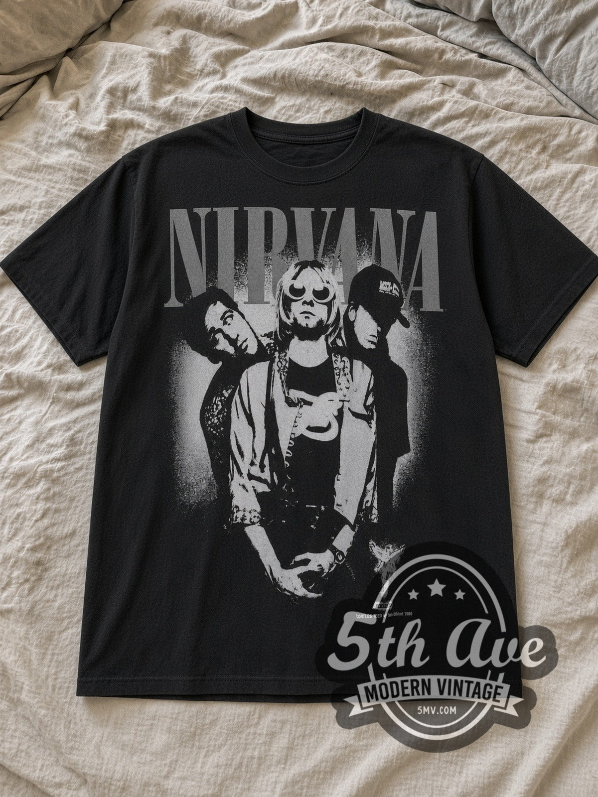 Black Nirvana Pink Stencil In Utero 1993 Vintage Band T-Shirt laid flat on a linen bed