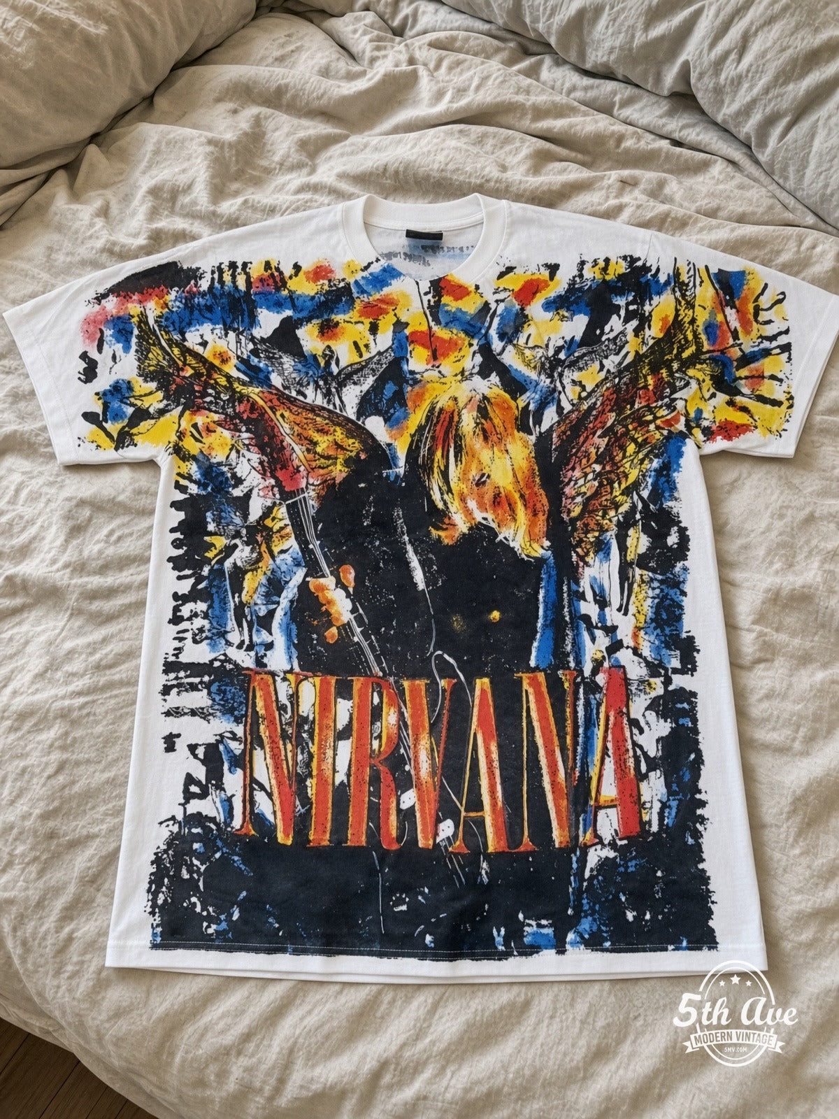Nirvana Faces Collage all over print vintage tee laid on bed