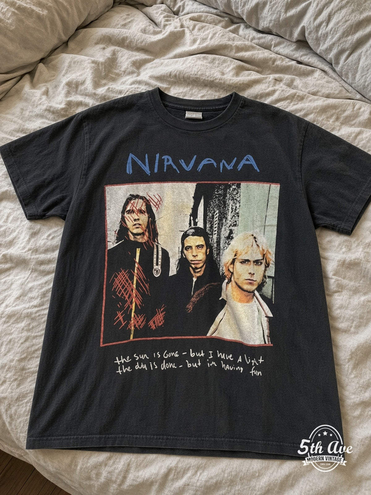 Nirvana Dumb Oh Our Last and Final Name vintage tee laid on bed