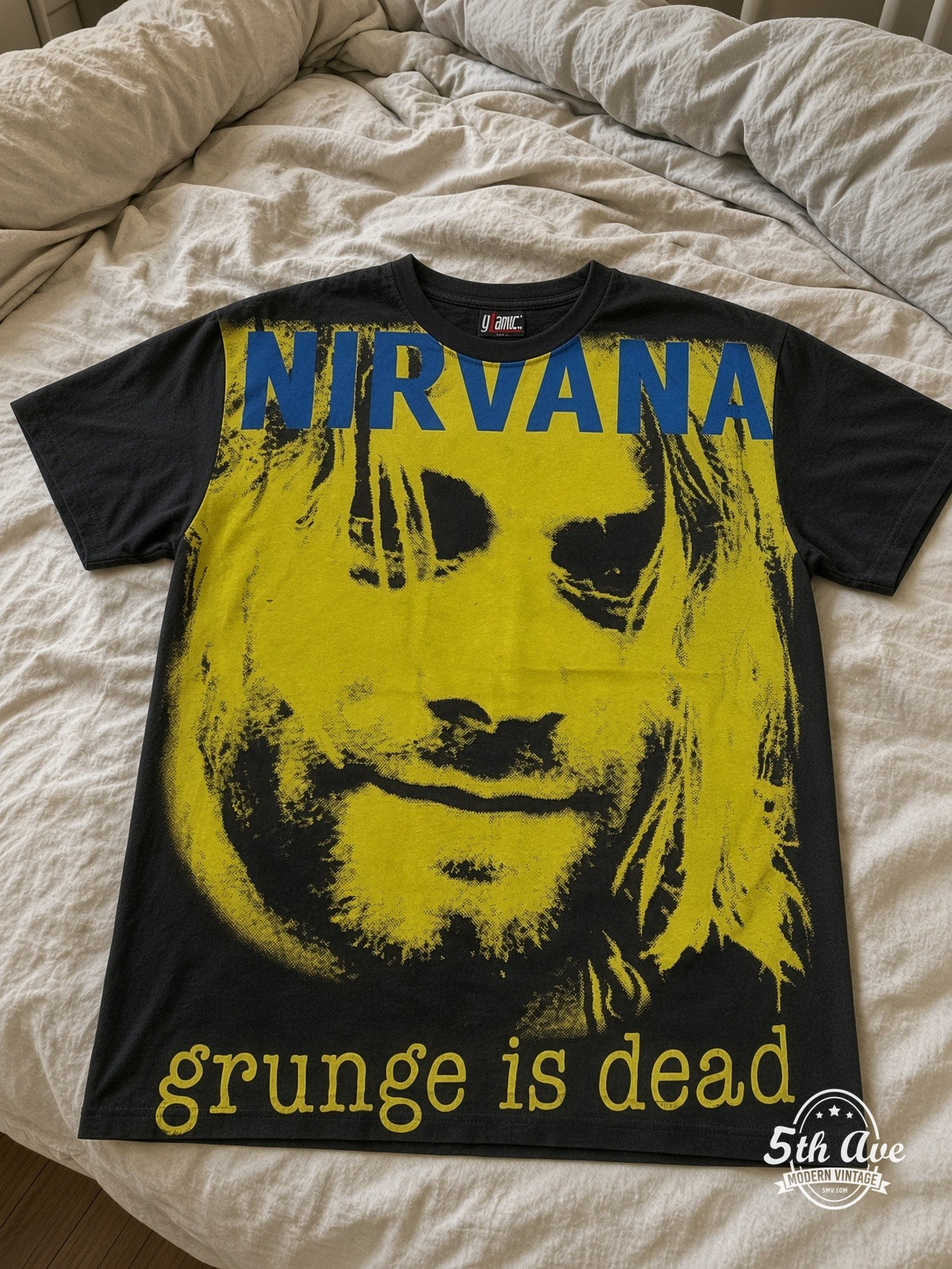 Nirvana Grunge Is Dead Yellow Kurt all over print vintage tee laid on bed