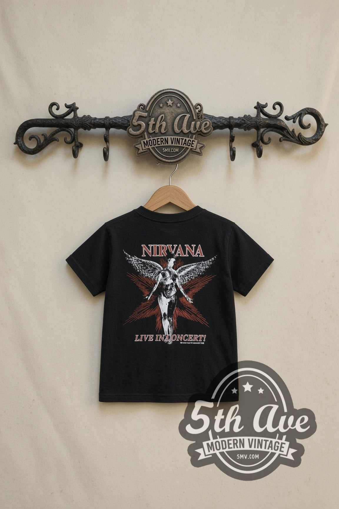 Nirvana In Concert Band Photo kids band tee in black, back view on a display rack