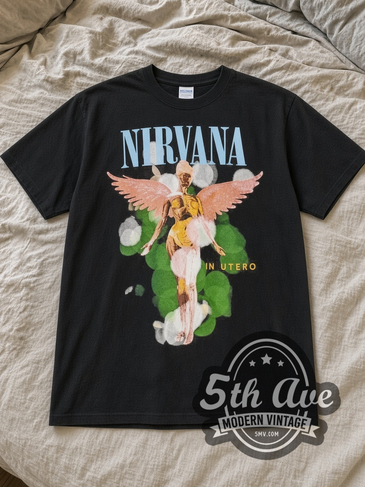 Black Nirvana In Utero Angel Aura Vintage Band T-Shirt laid flat on a linen bed