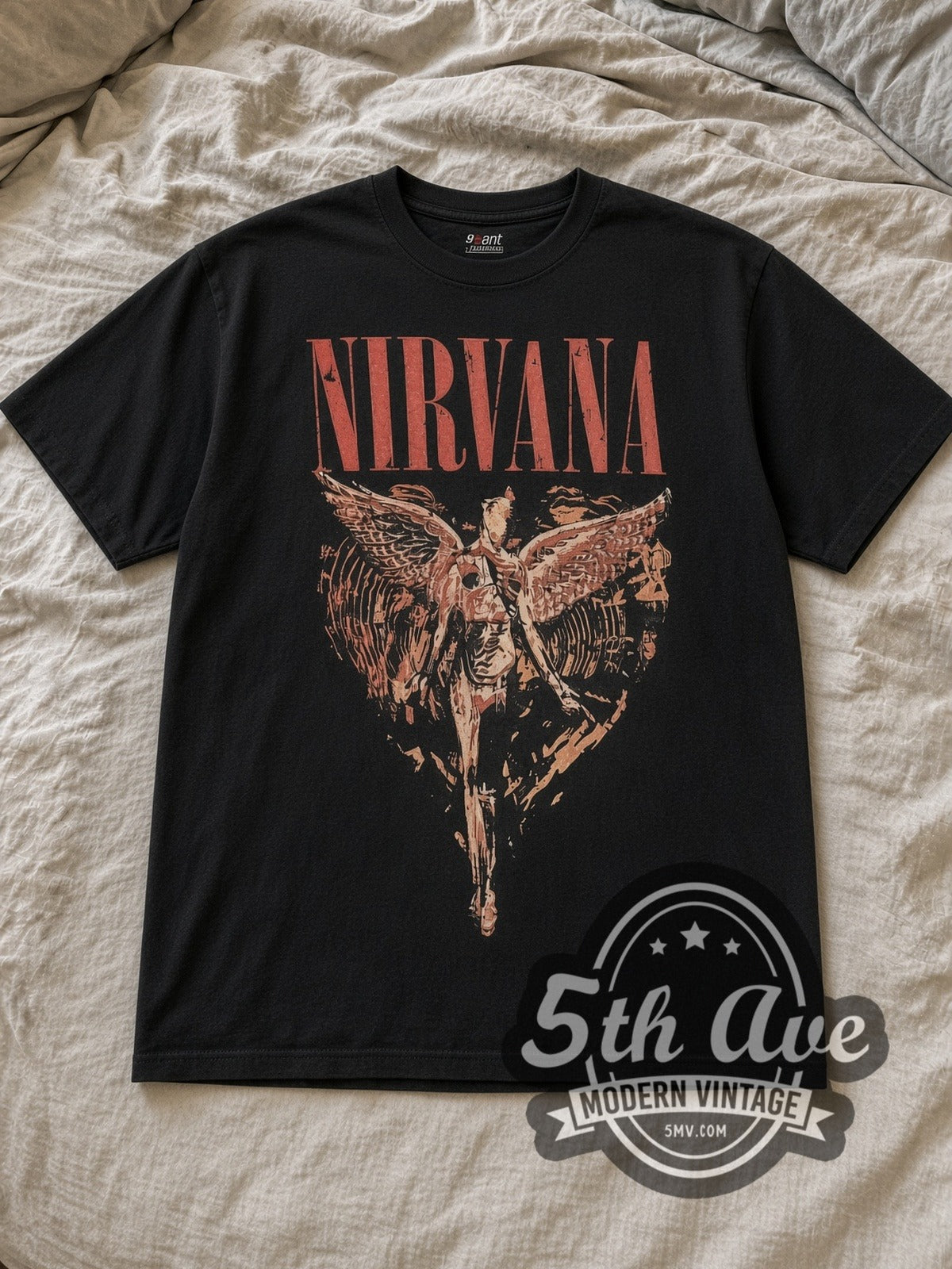 Black Nirvana In Utero Distressed Angel Yellow Back Print Vintage Band T-Shirt laid flat on a linen bed