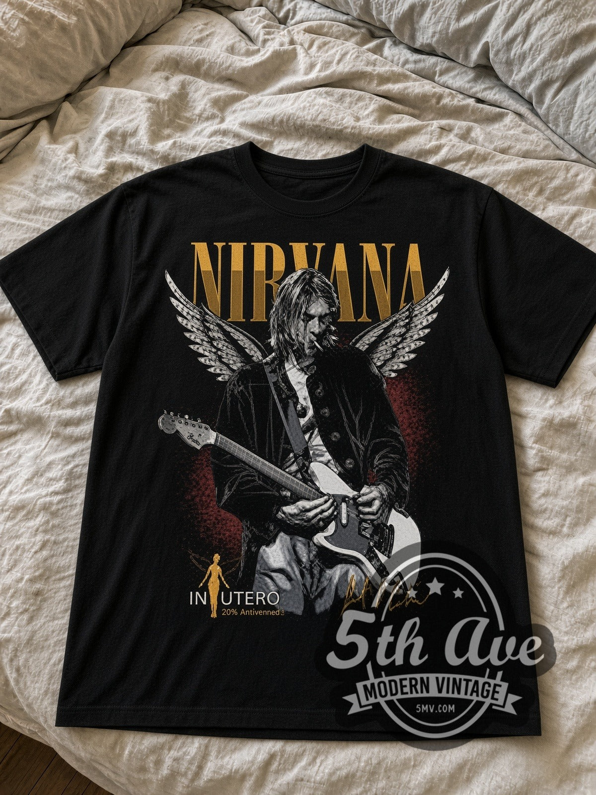 Nirvana Kurt Cobain In Utero Winged Guitar black graphic tee laid flat on linen bed