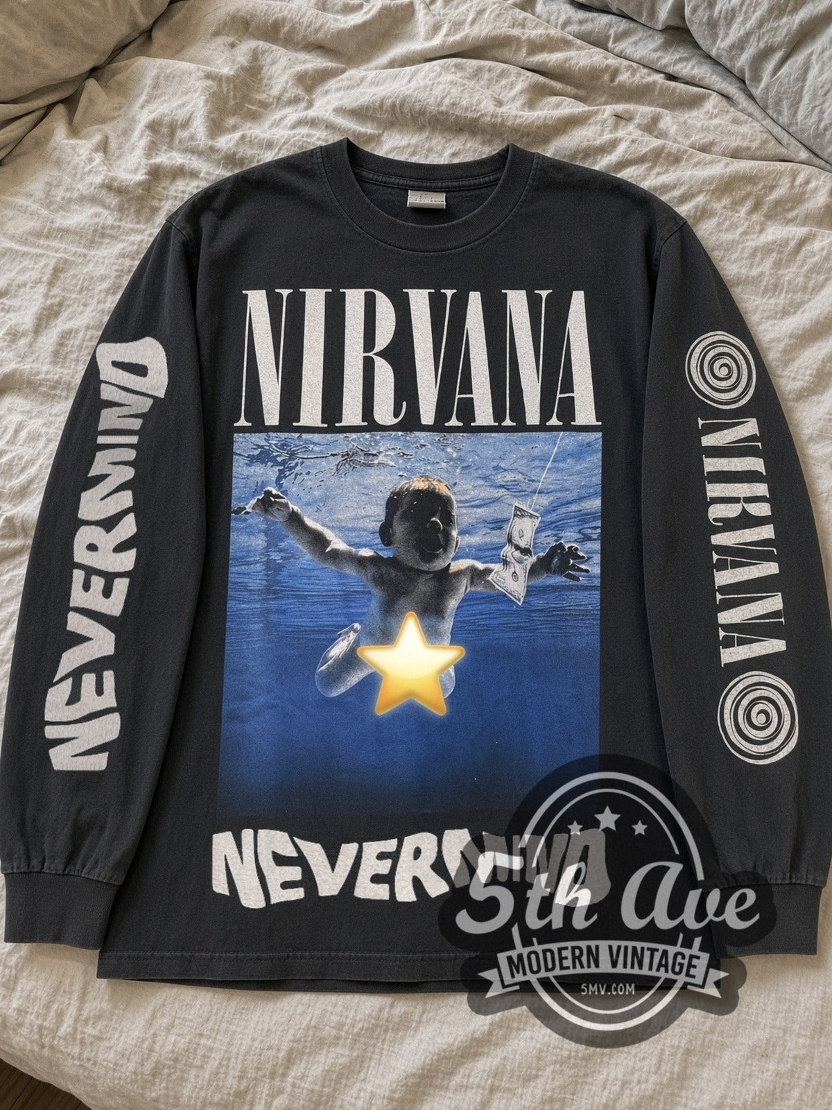 Black Nirvana Nevermind Star Baby long sleeve tee laid flat on linen bed