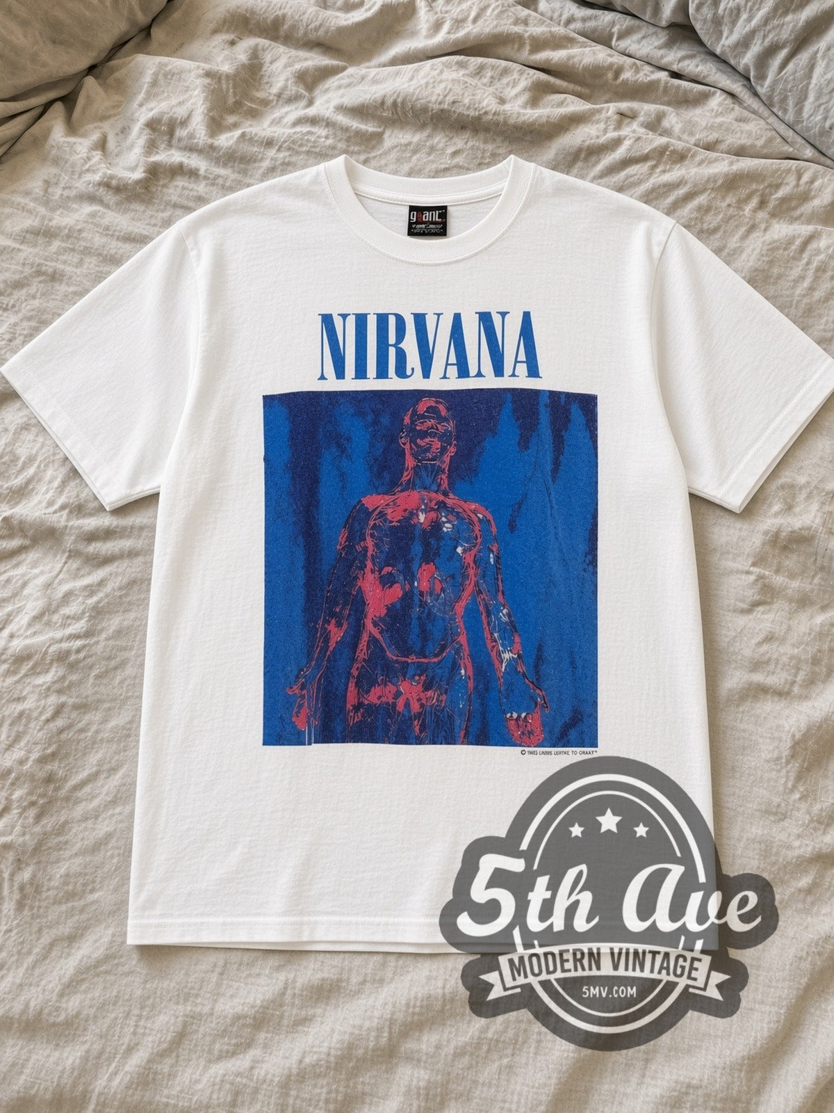 White Nirvana Sliver Blue Logo Anatomical Figure White Vintage Band T-Shirt laid flat on a linen bed