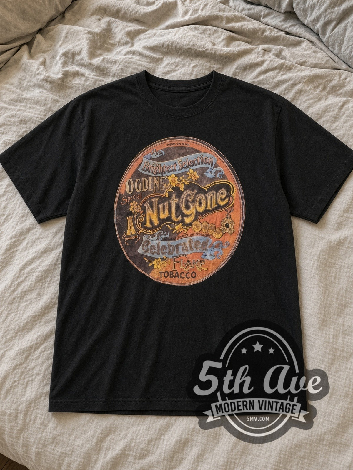 Black Woodstock Nut Gone Vintage Band T-Shirt laid flat on a linen bed
