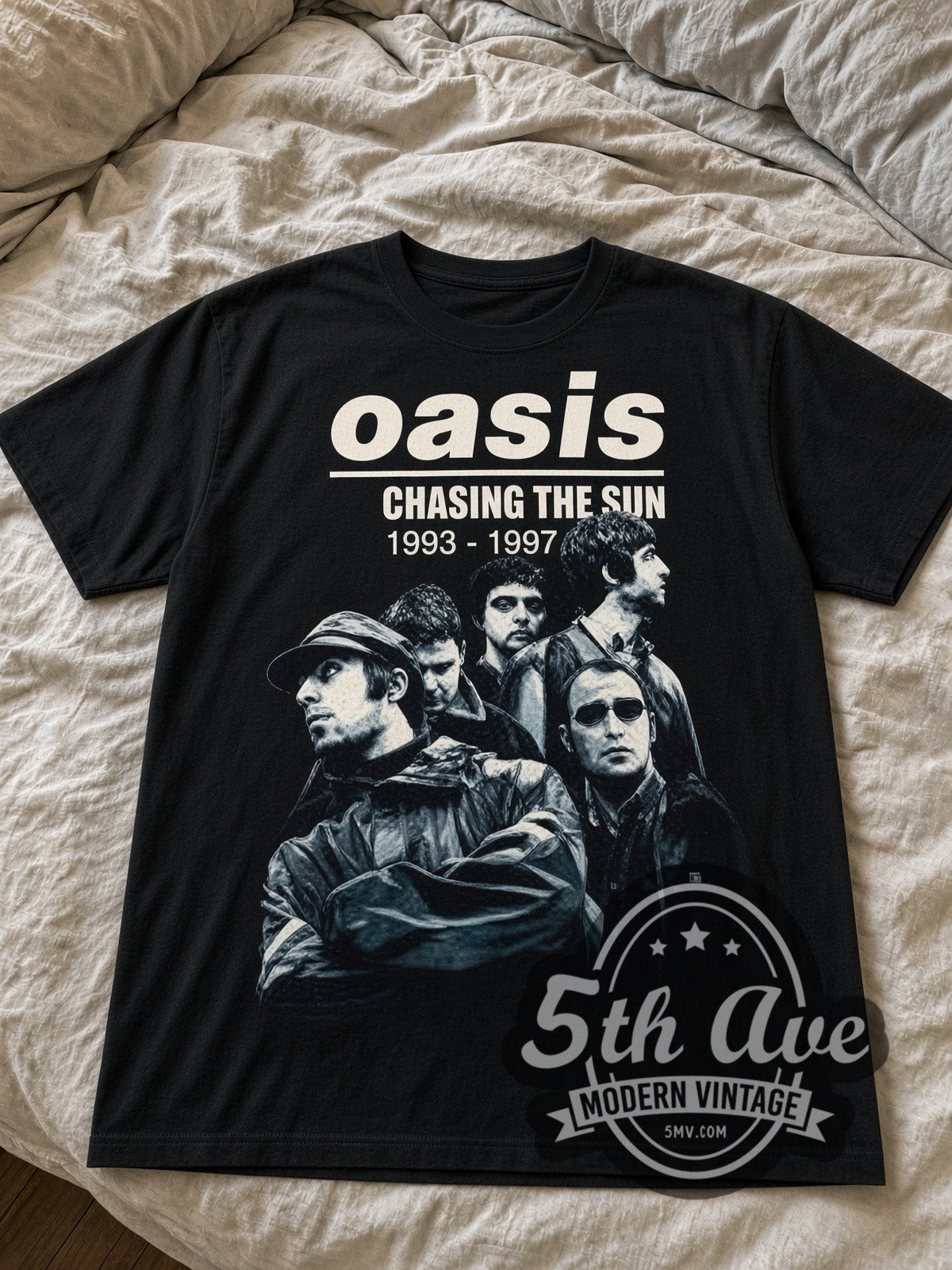 Oasis Chasing the Sun 1993-1997 black graphic tee laid flat on linen bed