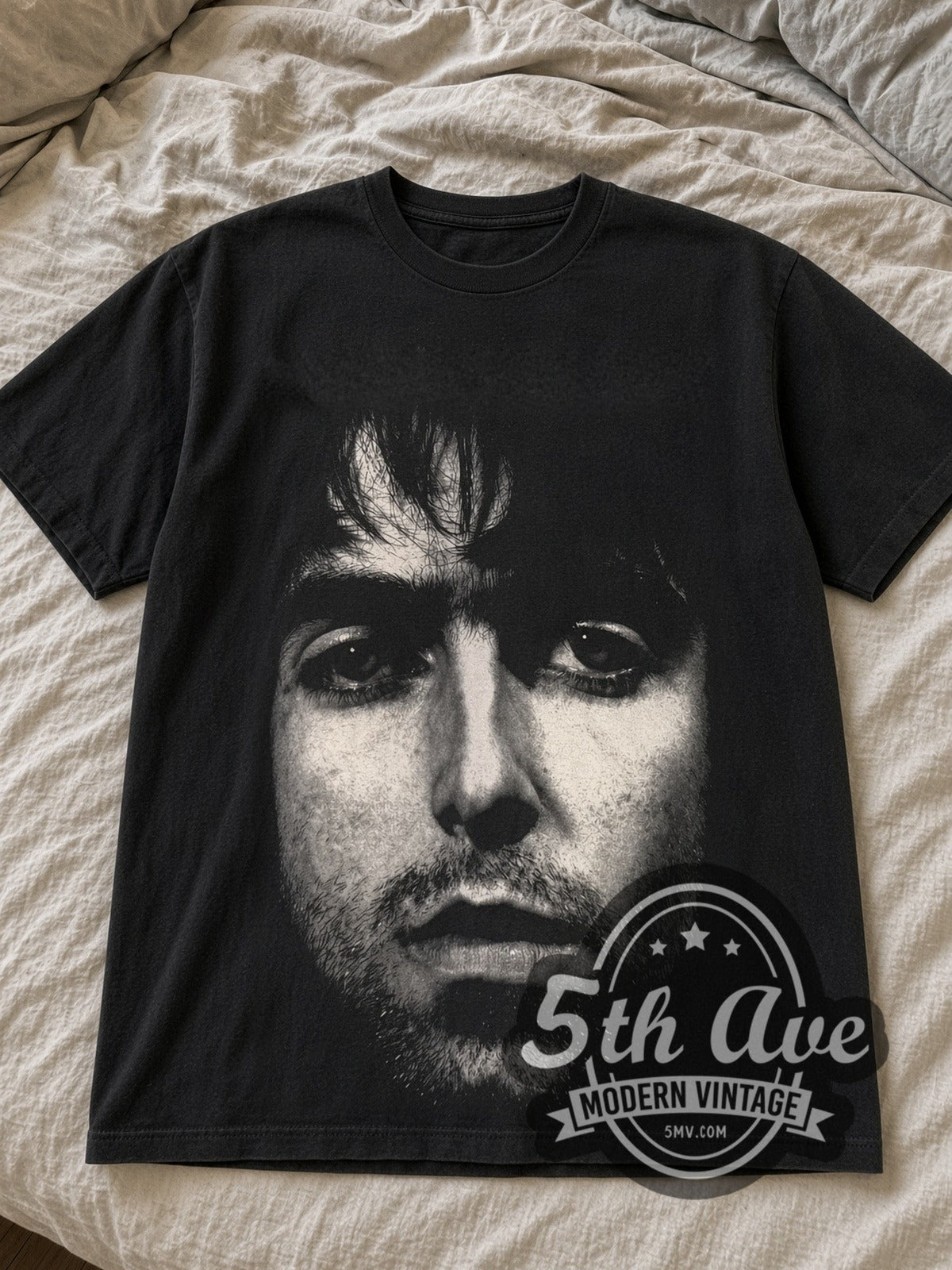 Black Oasis Liam Face & Keys tee laid flat on linen bed