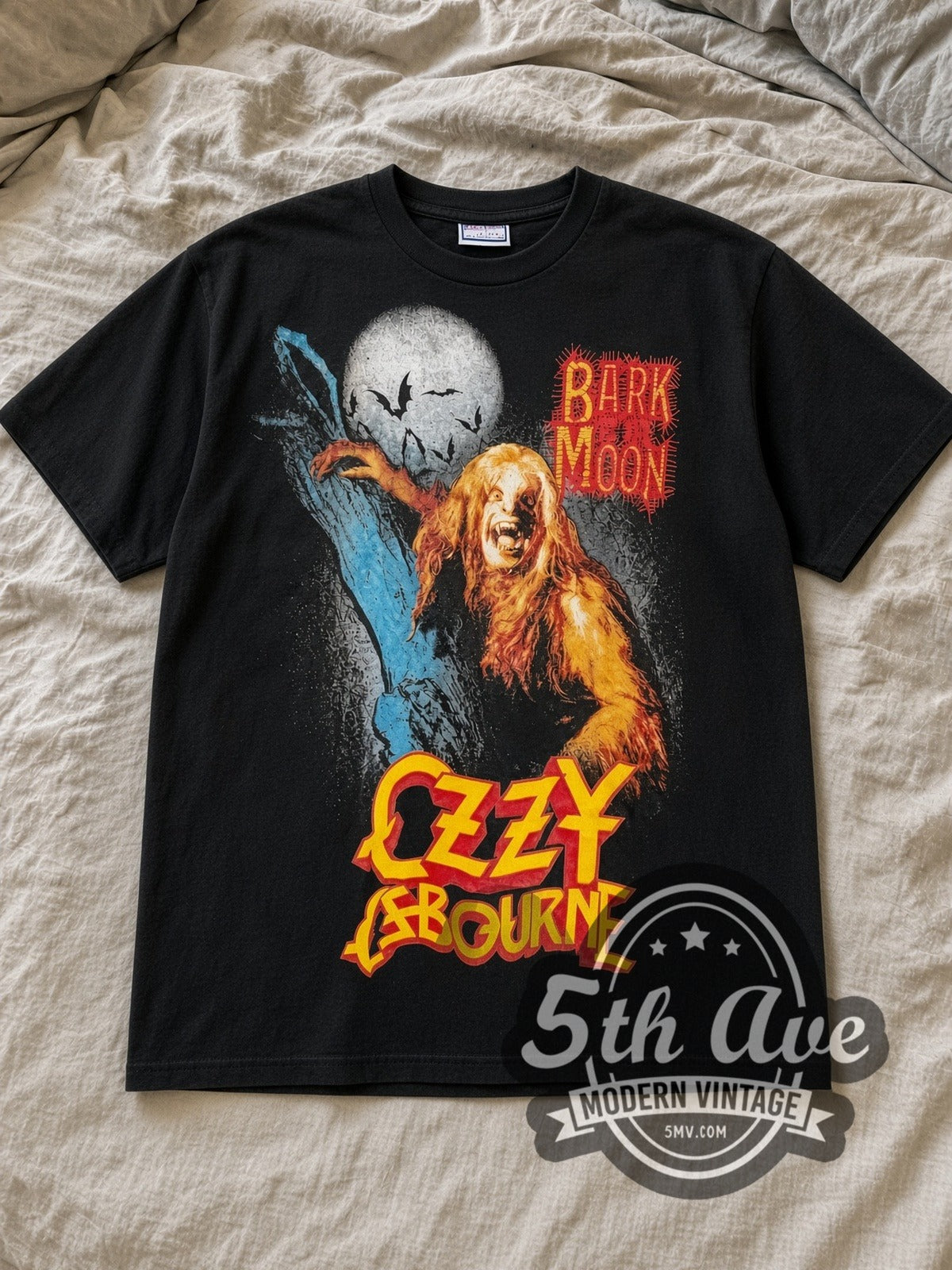 Black Ozzy Osbourne Bark at the Moon Vintage Band T-Shirt laid flat on a linen bed