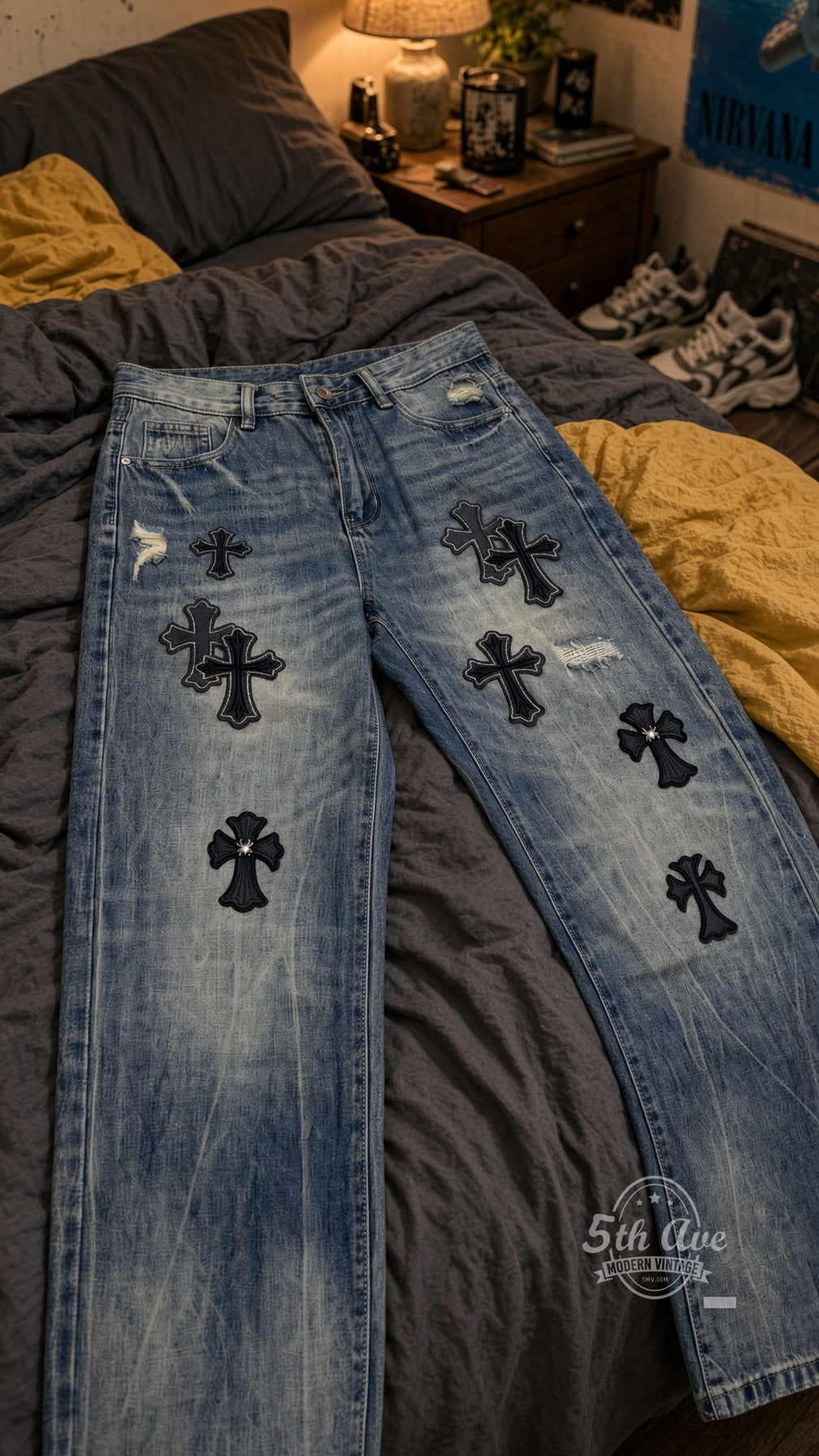 Black Gothic Cross Appliqué Jeans laid on bed