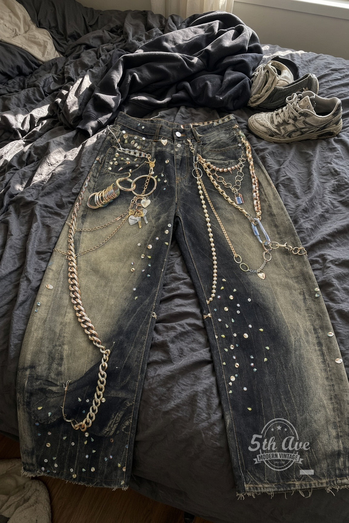 Dirty Wash Trompe L'oeil Jewelry Print Streetwear Jeans laid on bed