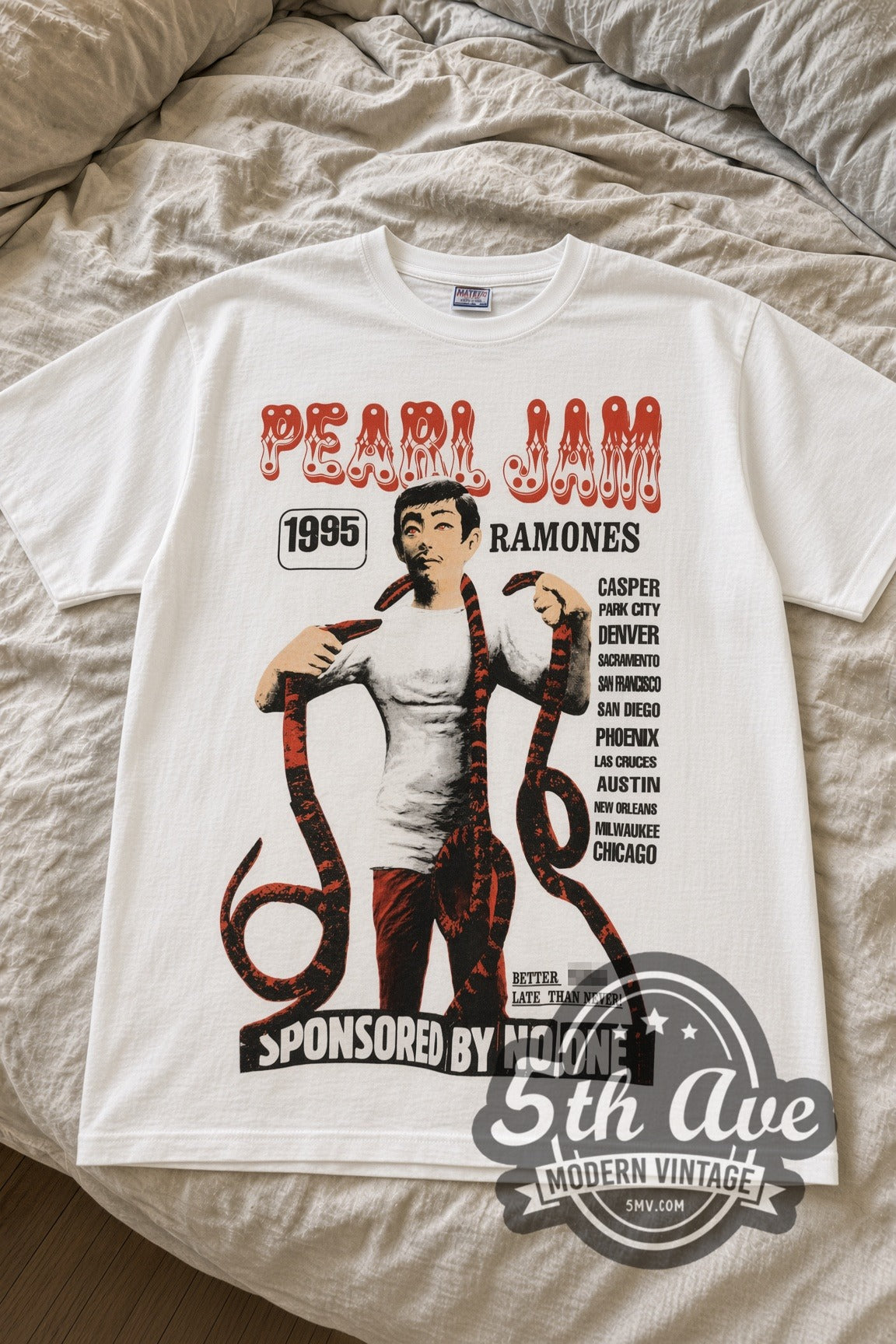 Pearl Jam and Ramones 1995 Snake Man Sponsored by No One vintage band t-shirt laid flat on bed