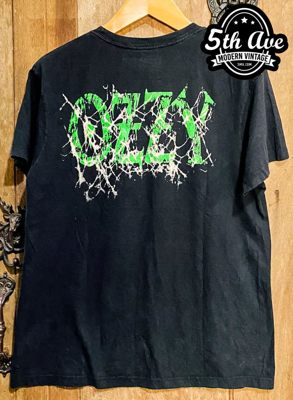 Ozzy Osbourne Cobweb Design Tee: A Hauntingly Stylish Tribute to the Rock Icon vintage t-shirt laid on bed