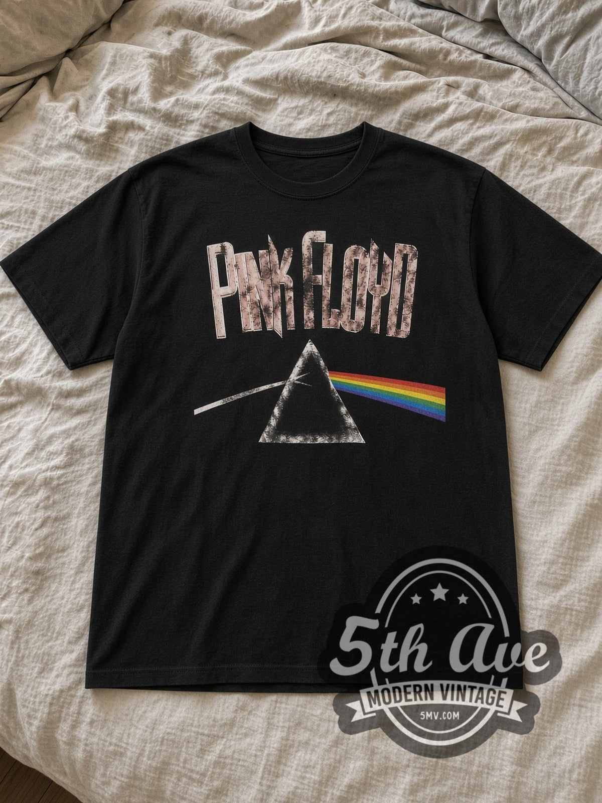 Black Pink Floyd Dark Side of the Moon Prism Vintage Band T-Shirt laid flat on a linen bed