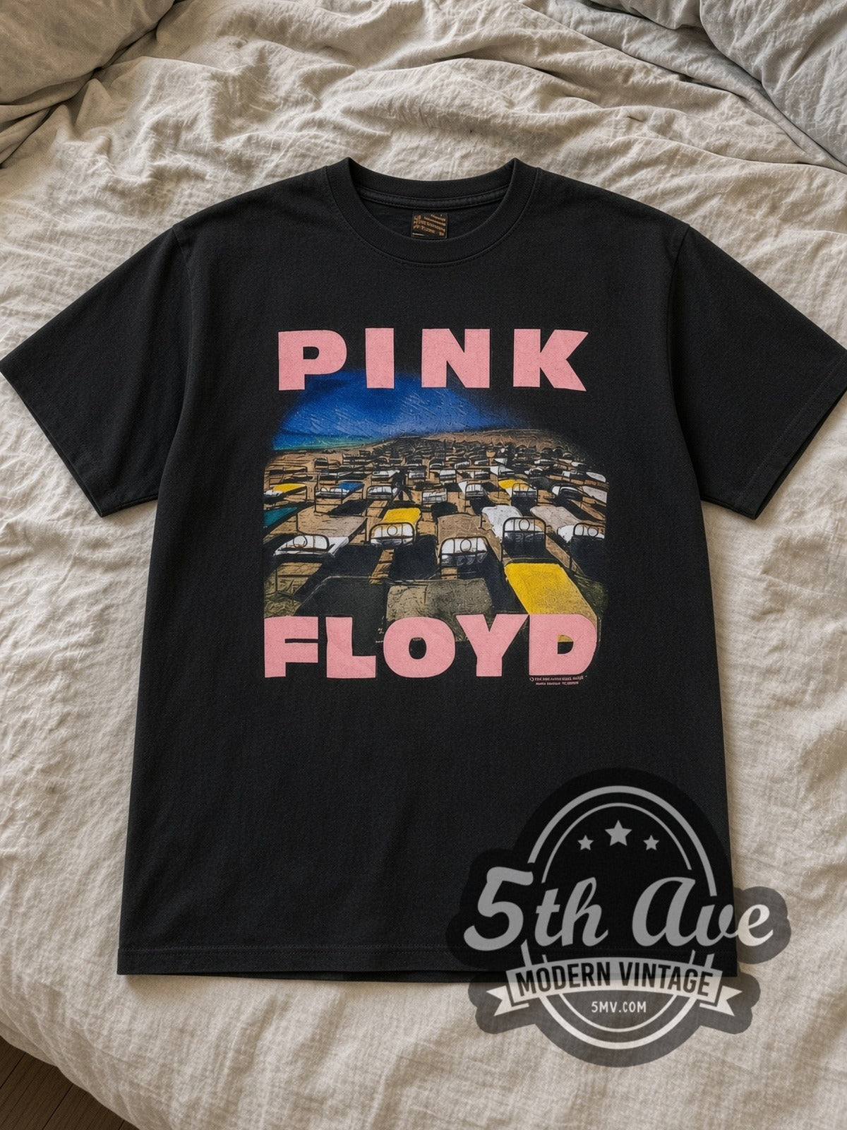 Black Pink Floyd A Momentary Lapse of Reason Vintage Band T-Shirt laid flat on a linen bed