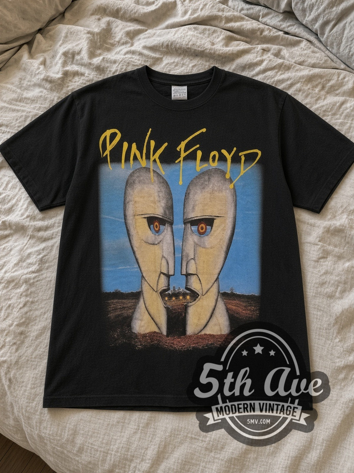 Black Pink Floyd The Division Bell Vintage Band T-Shirt laid flat on a linen bed