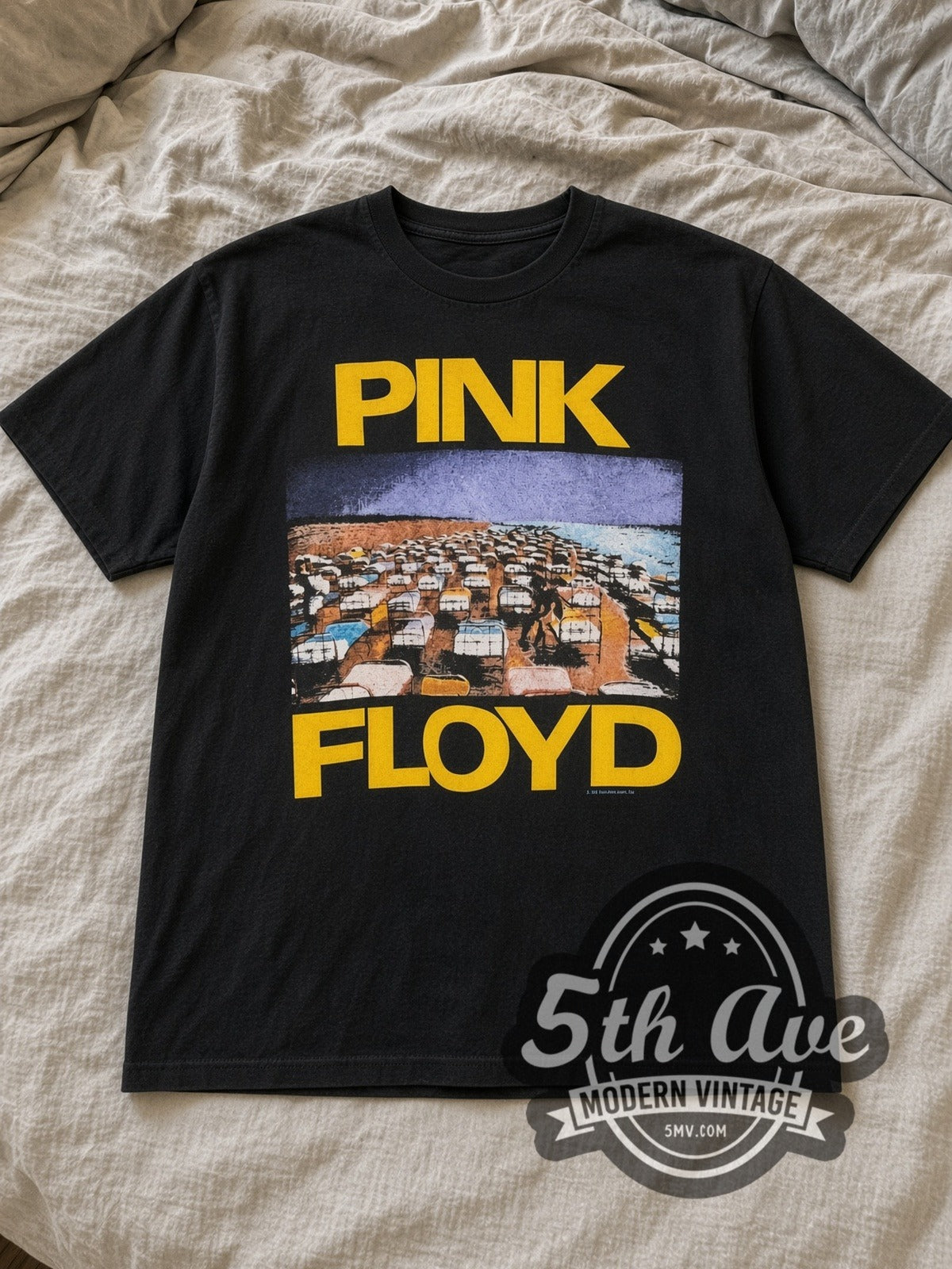 Black Pink Floyd World Tour 1987 Vintage Band T-Shirt laid flat on a linen bed