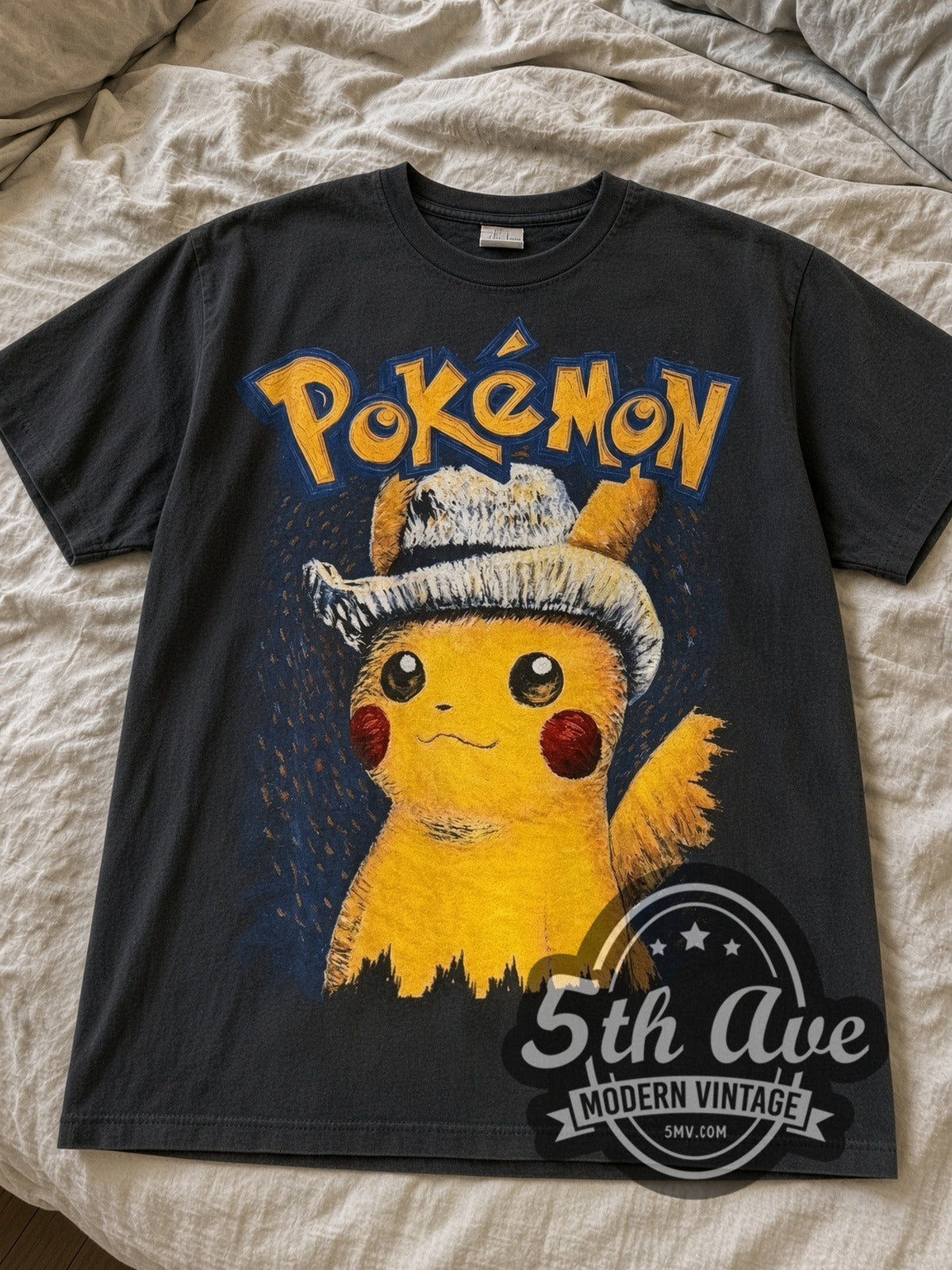 Faded black Pokémon Van Gogh Pikachu & Eevee tee laid flat on linen bed
