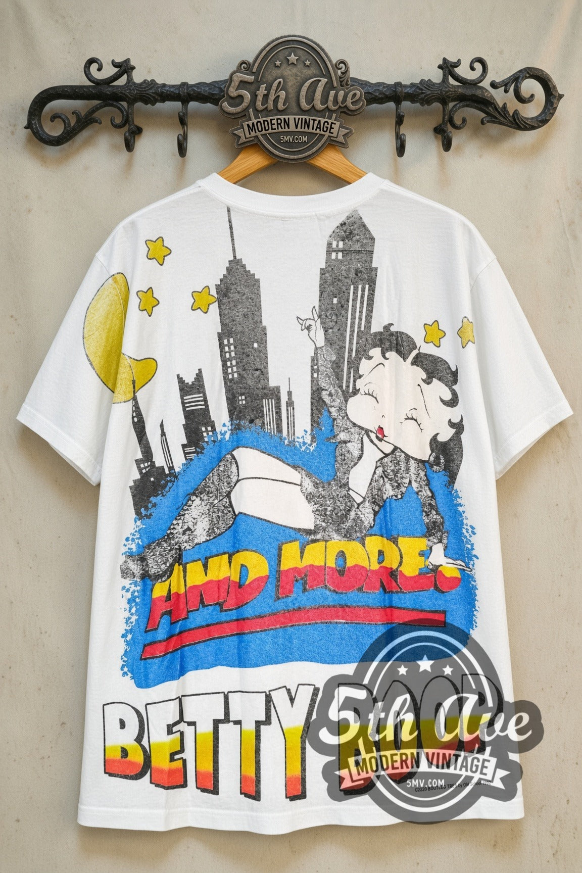 Betty Boop Guest List Only all-over-print vintage cartoon tee, back view on a display rack