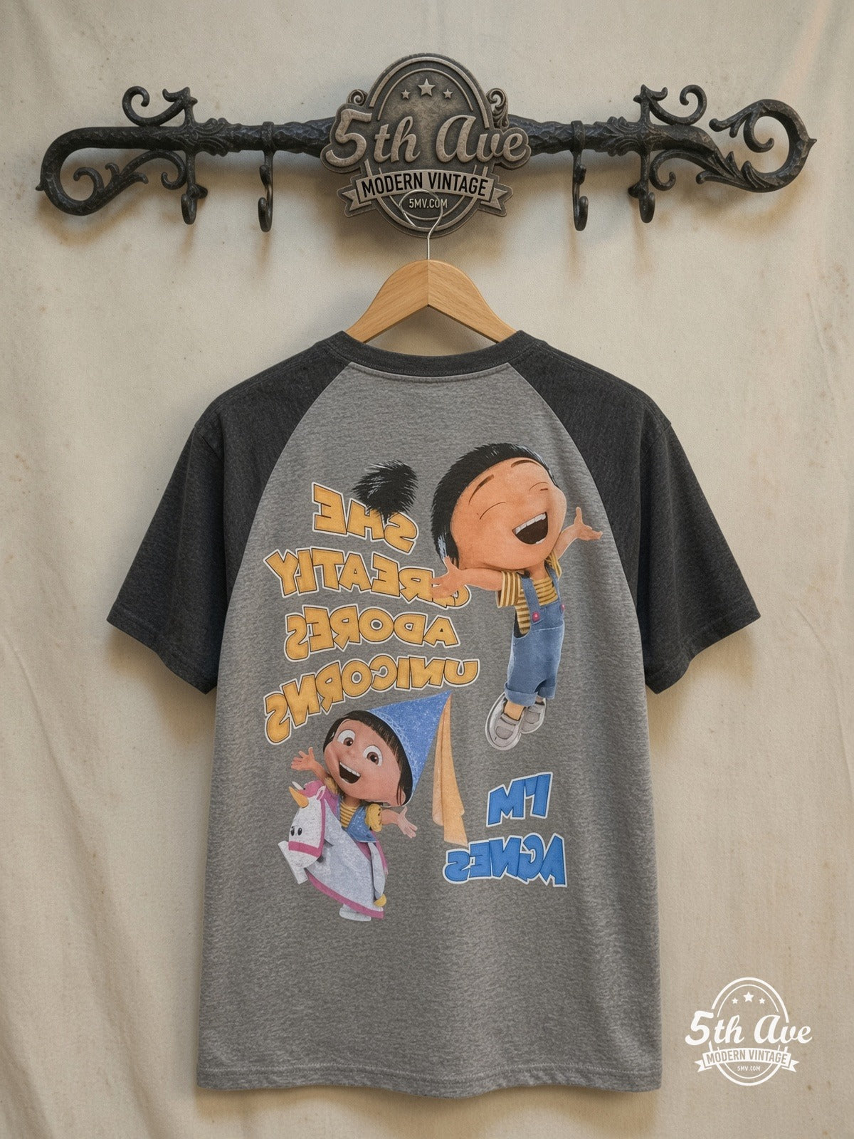 Despicable Me Agnes and Her Unicorn Adventure t shirt — back on locked cream ornate 5th Ave rack