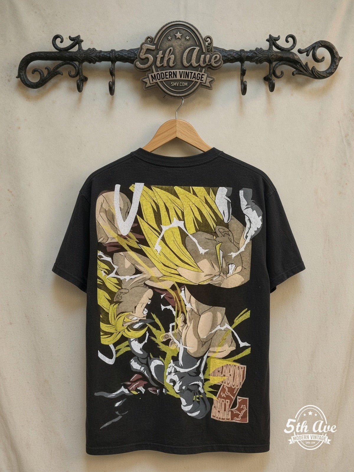 Unleashed Power: Goku's Evolution and Eternal Rivalry – All Over Print – New Vintage Anime Tee — back on locked cream ornate 5th Ave rack